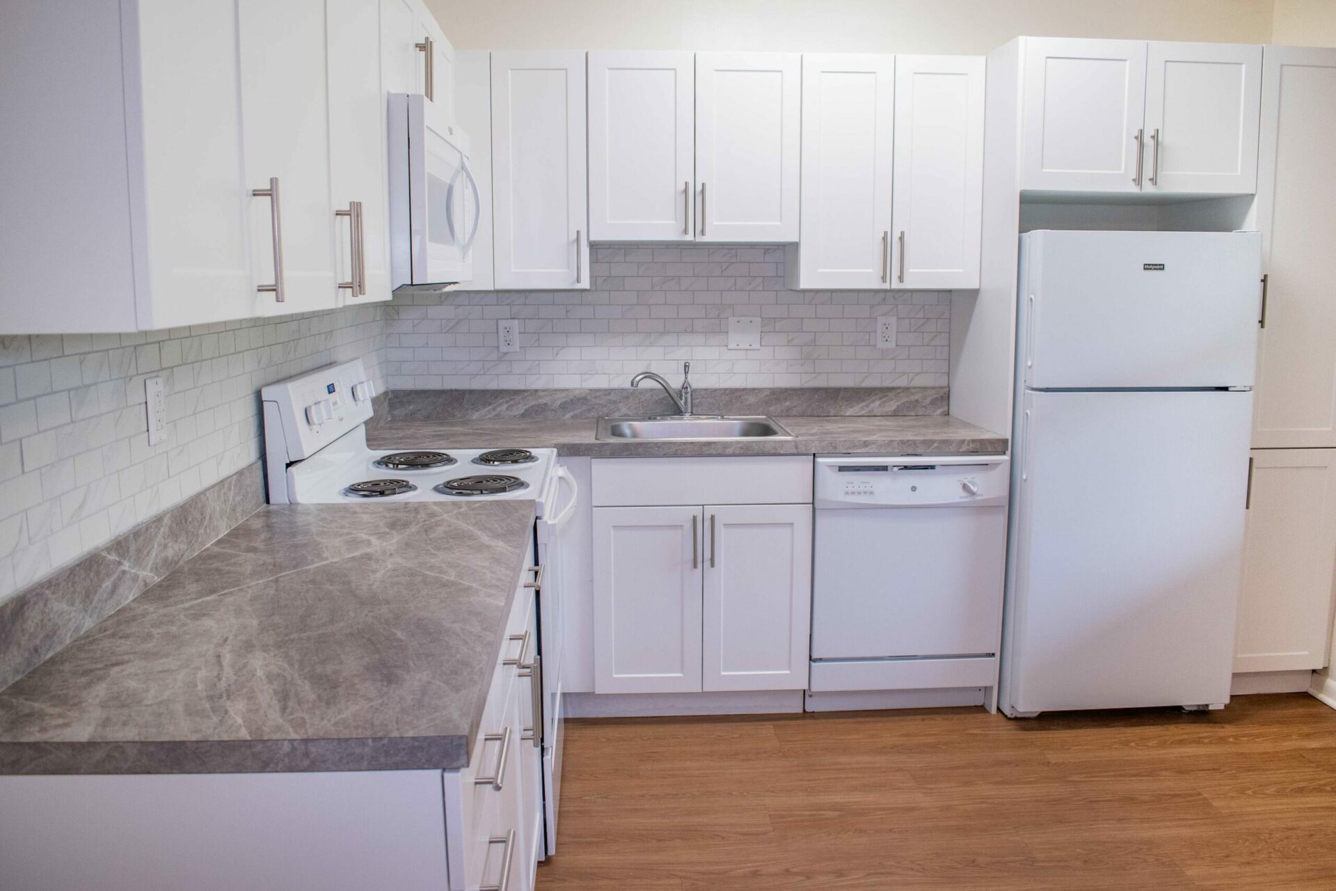 Westover Village Apartments kitchen with white cabinets and white appliances