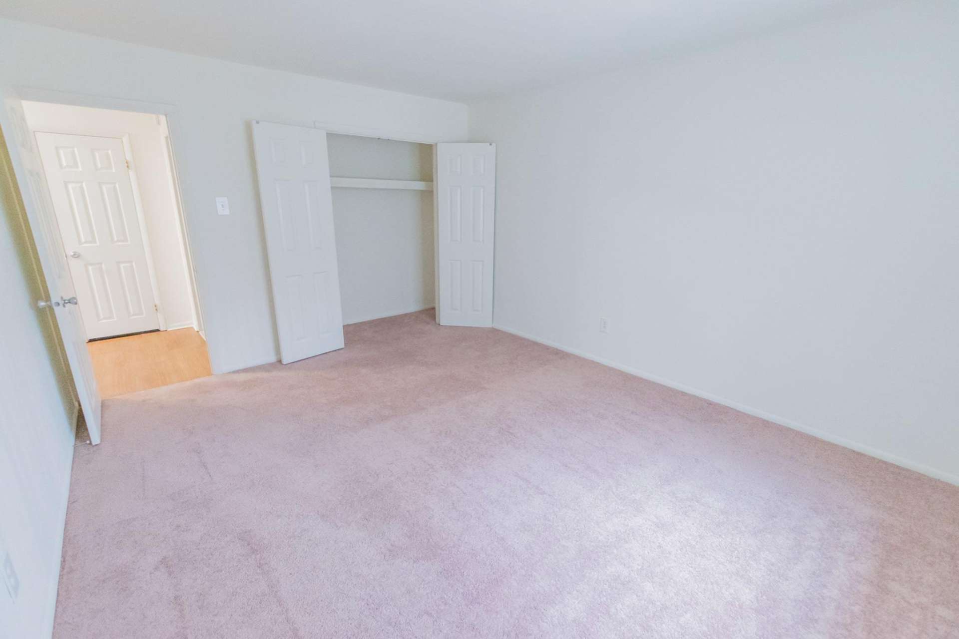 Carpeted bedroom with a closet in an apartment at Hollow Run.