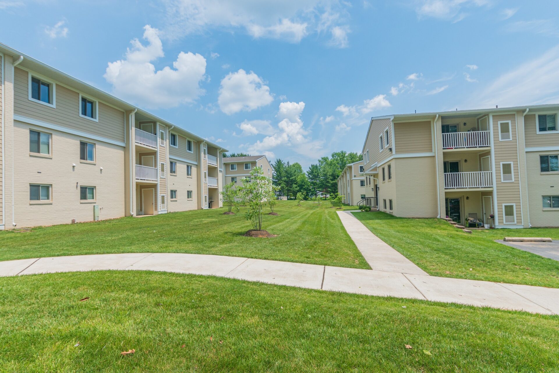 Exterior area of apartment building at Caln East, fitted with a lawn, and a paved walkway