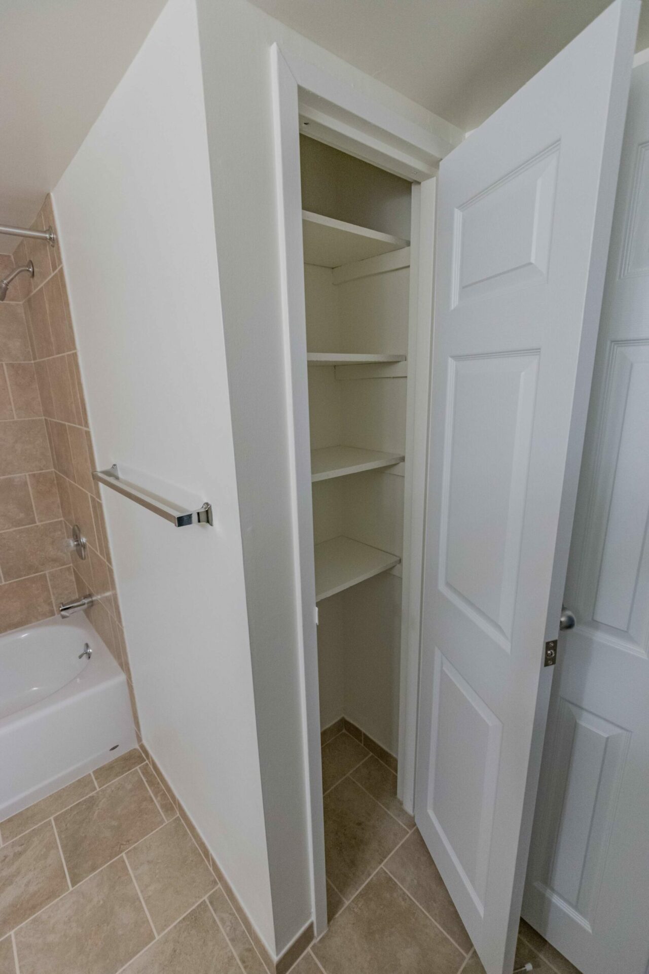 Shelving area in bathroom of an apartment, fitted with various shelves