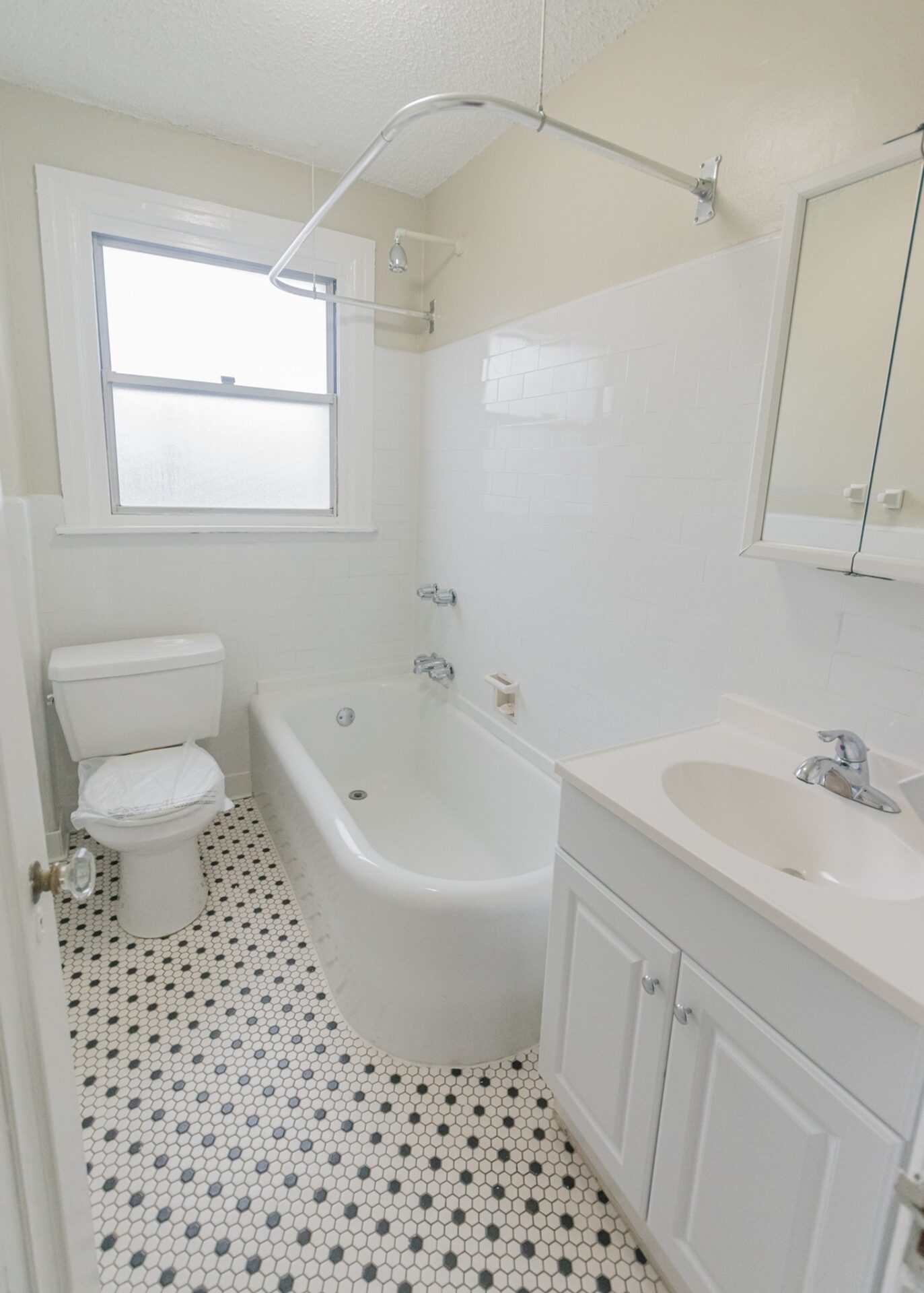 Suburban Court tiled bathroom with large tub and shower.