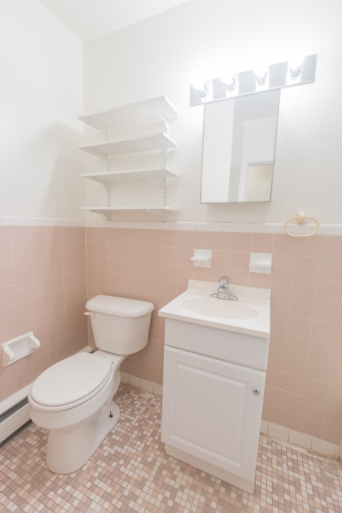Bathroom with light pink tiles in Sherman Court Apartments.