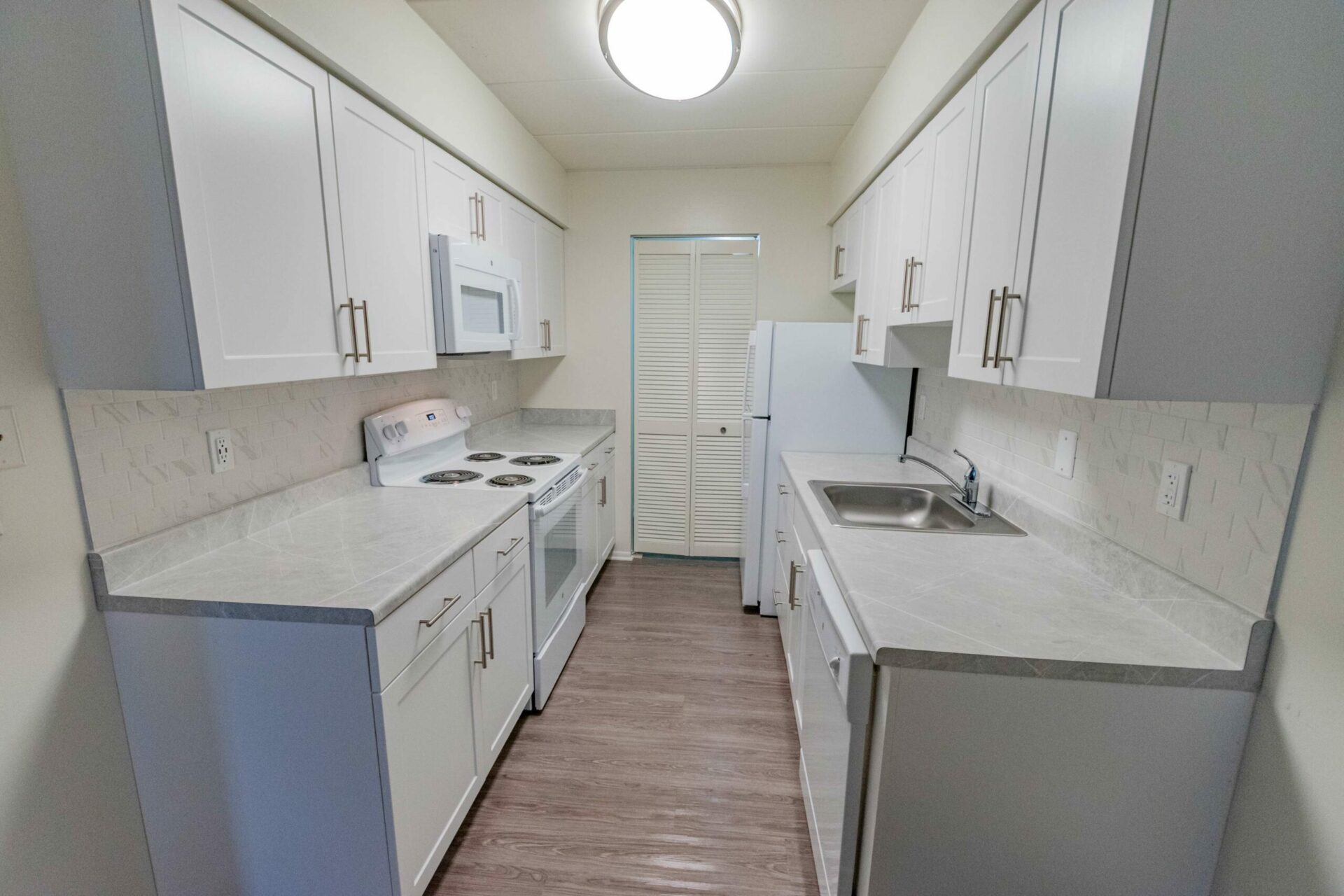 Galley Kitchen with white appliances at Whiteland West Apartments