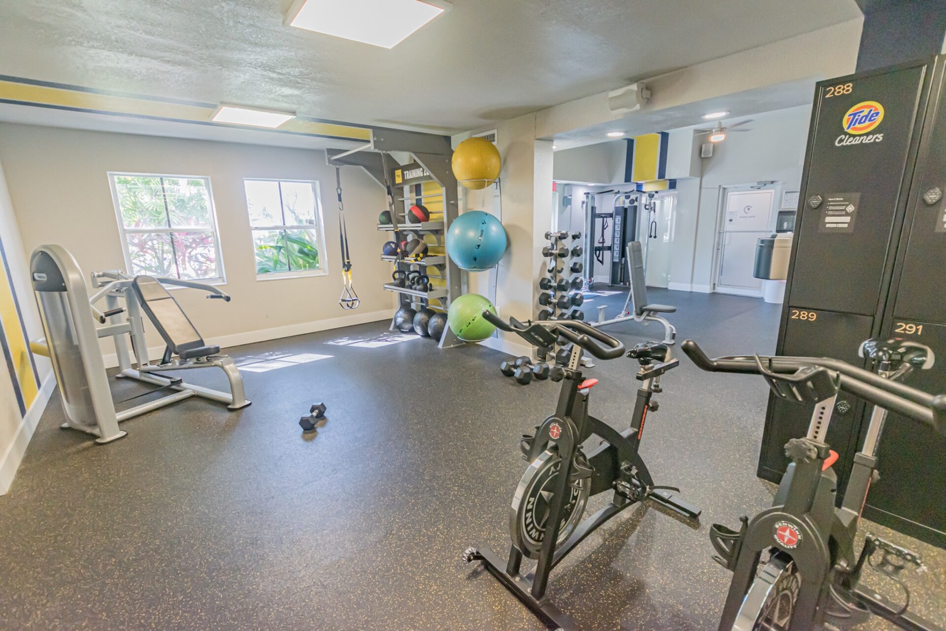 Indoor gym with a variety of workout equipment.