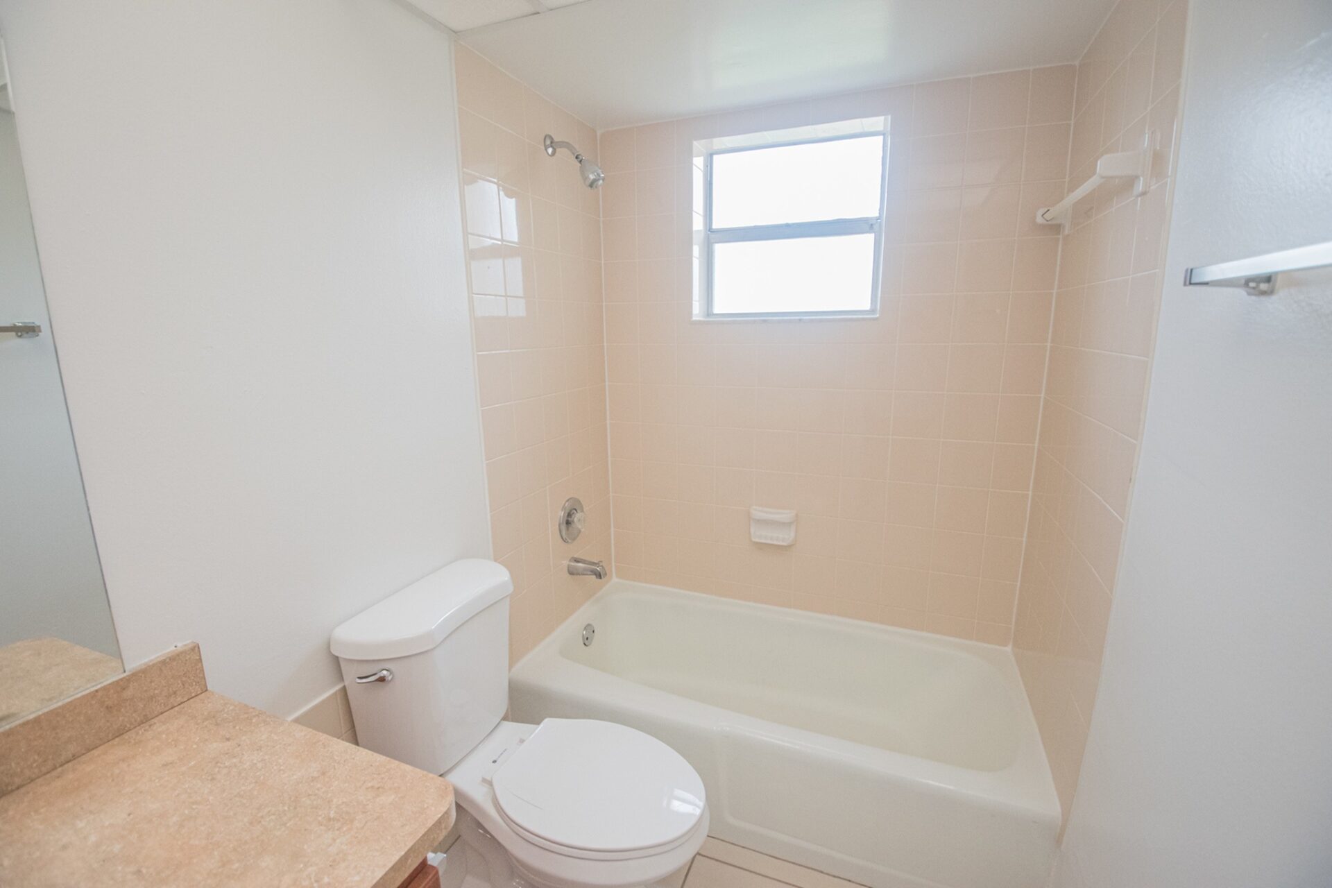 Bathtub and toilet inside a bathroom in an apartment at Green Briar West.