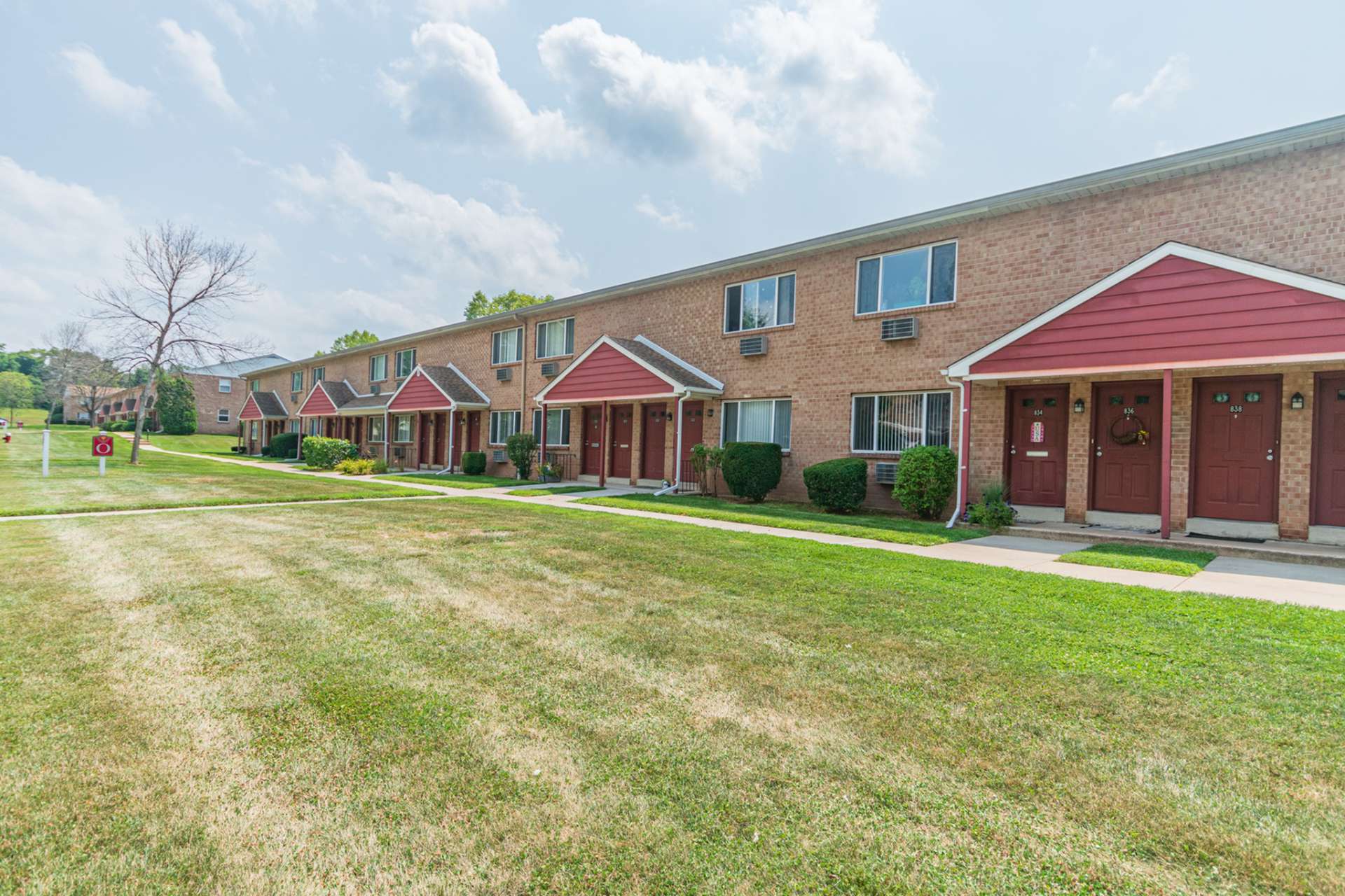 Exterior of Independence Crossing Apartments with sidewalks and large grassy areas.