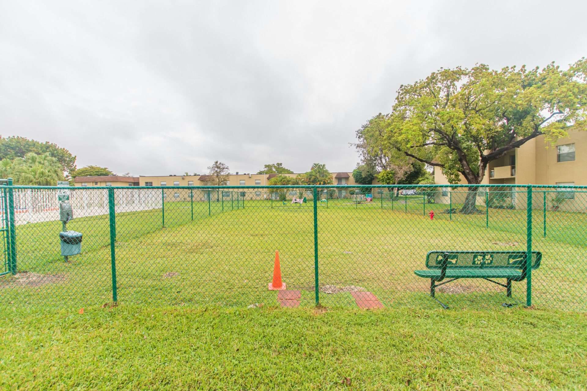 Fenced-in dog park next to the fenced-in pool area at Green Briar West in Miami, FL.