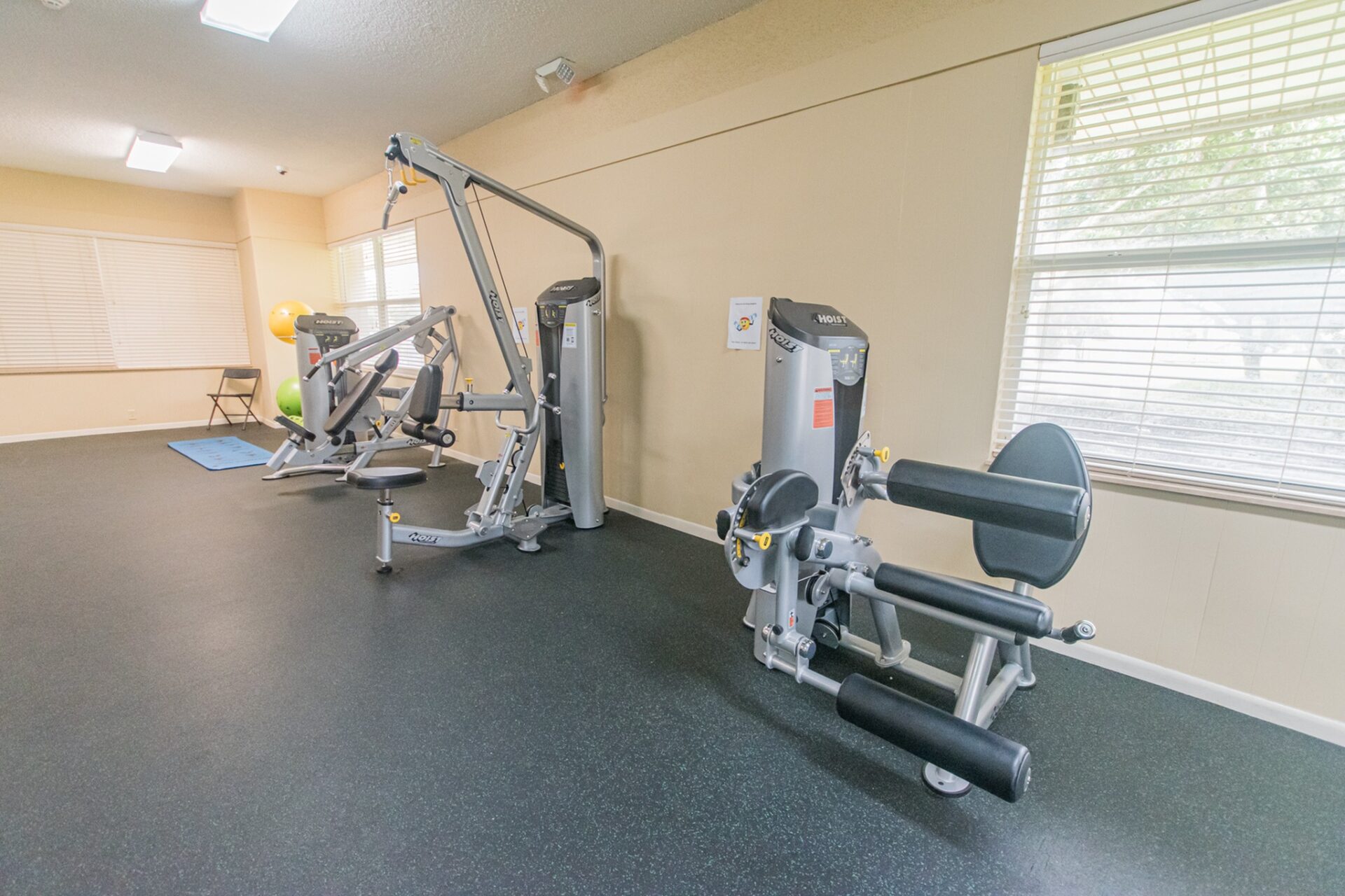 A variety of workout equipment at an indoor gym.