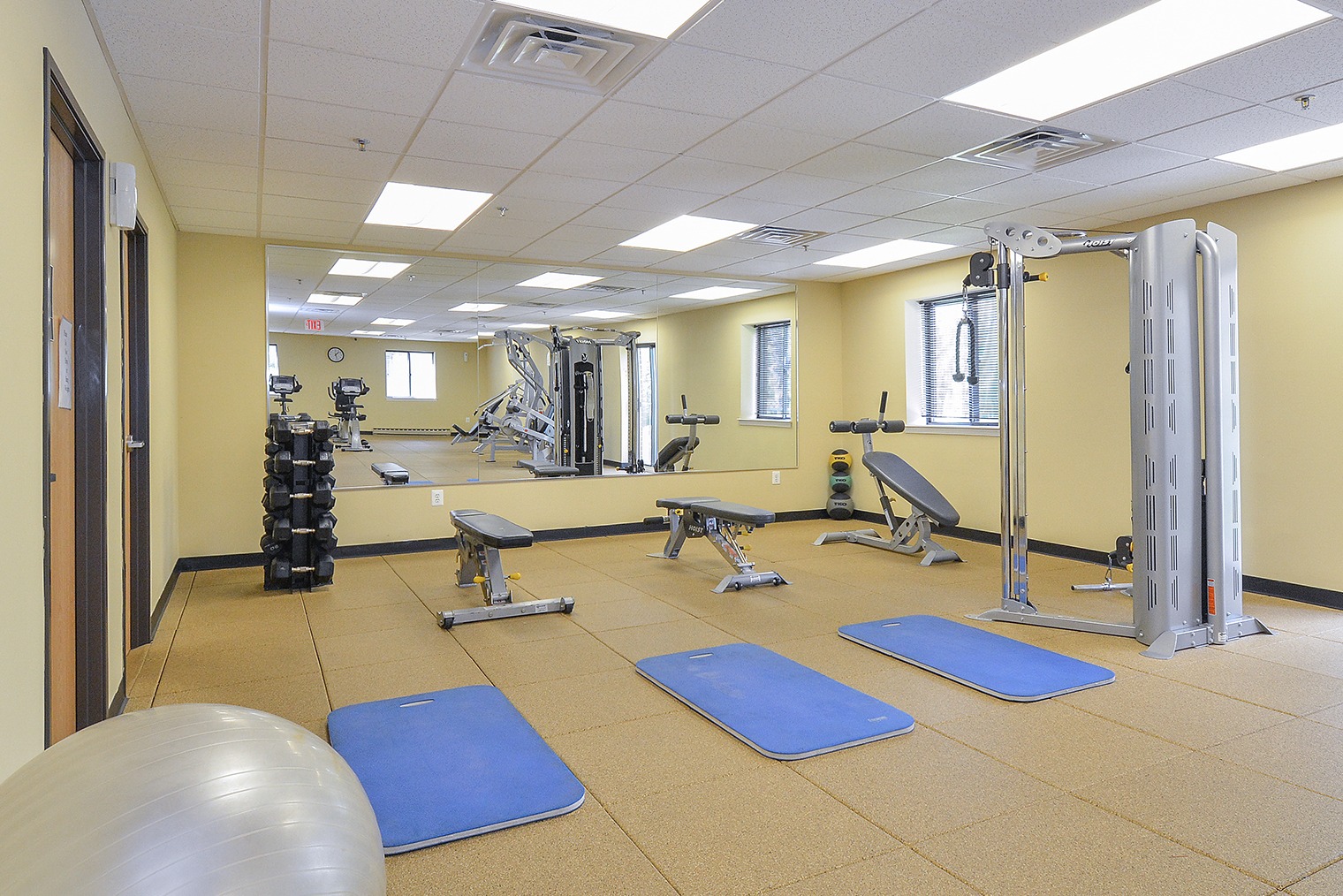 Fitness center with mats and exercise machines at Valley Forge Suites