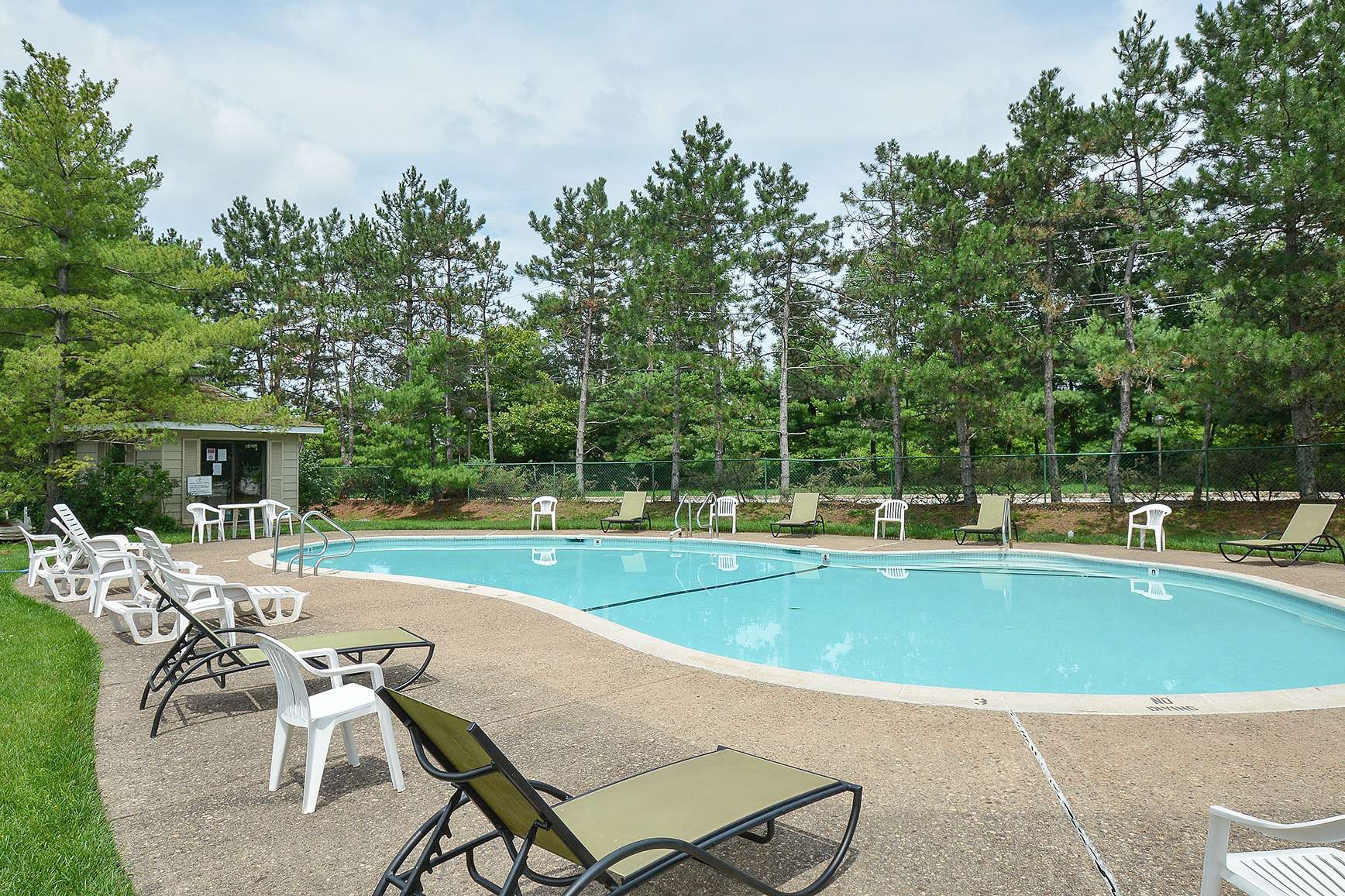 Large pool area surrounded by lounge chairs at Valley Forge Suites
