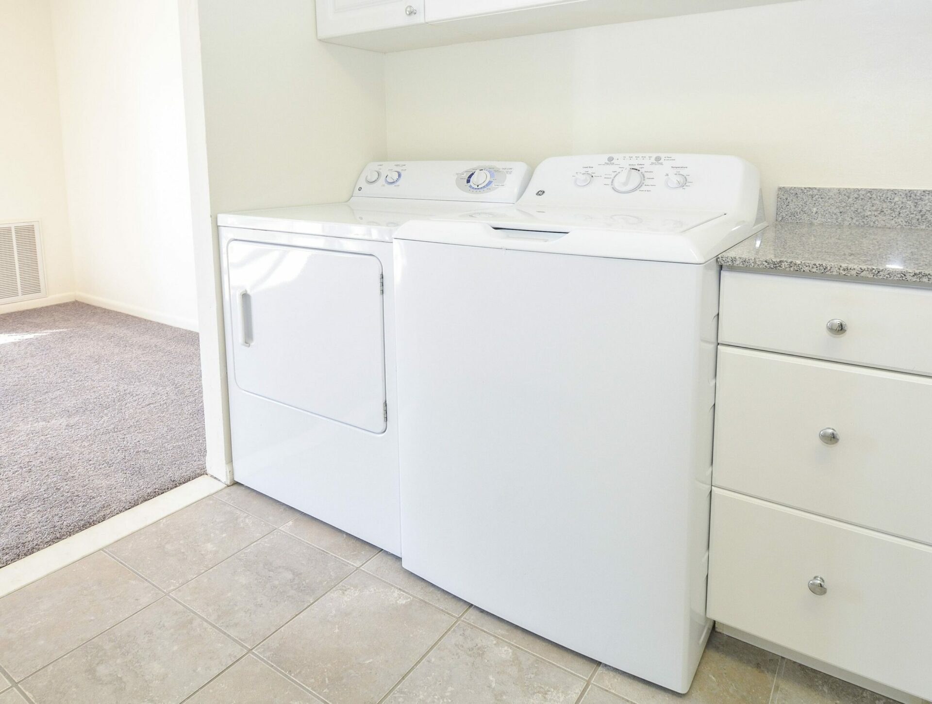 Washer and dryer side by side in an apartment at Main Line Berwyn.