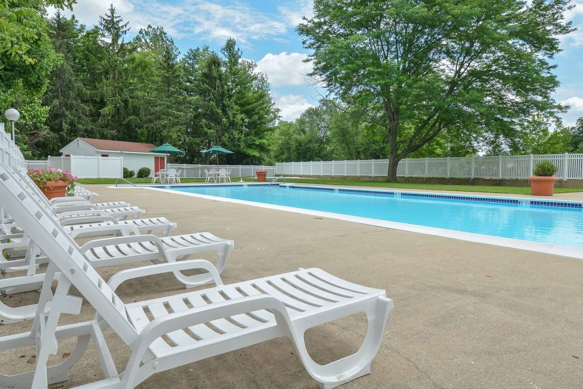 Large pool with lounge chairs at Whiteland West Apartments
