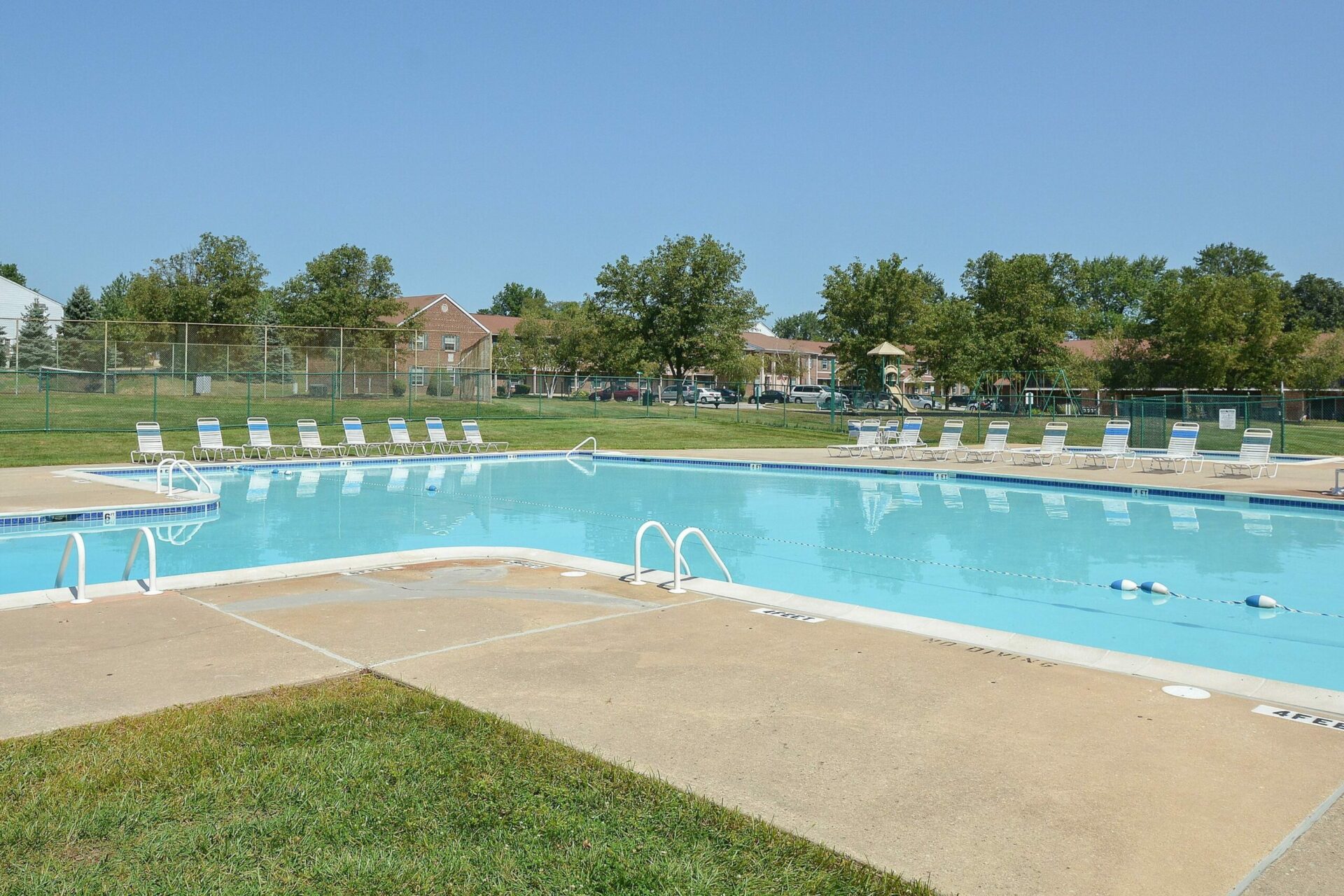 Large L-shaped dazzling pool with loungers at Westover Village