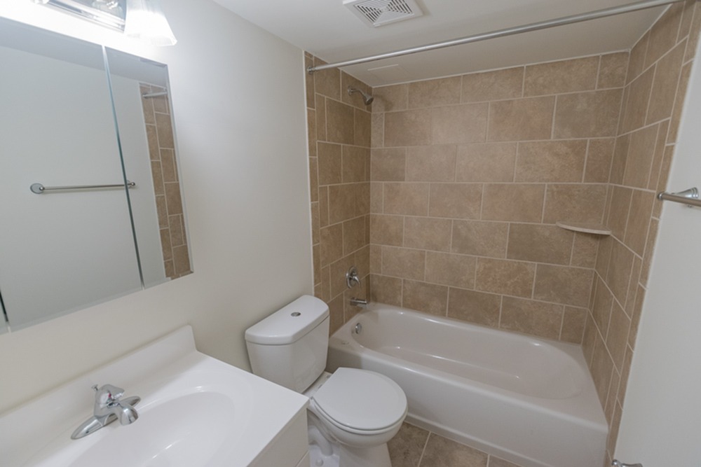 Tiled bathroom and shower at The Lafayette apartments