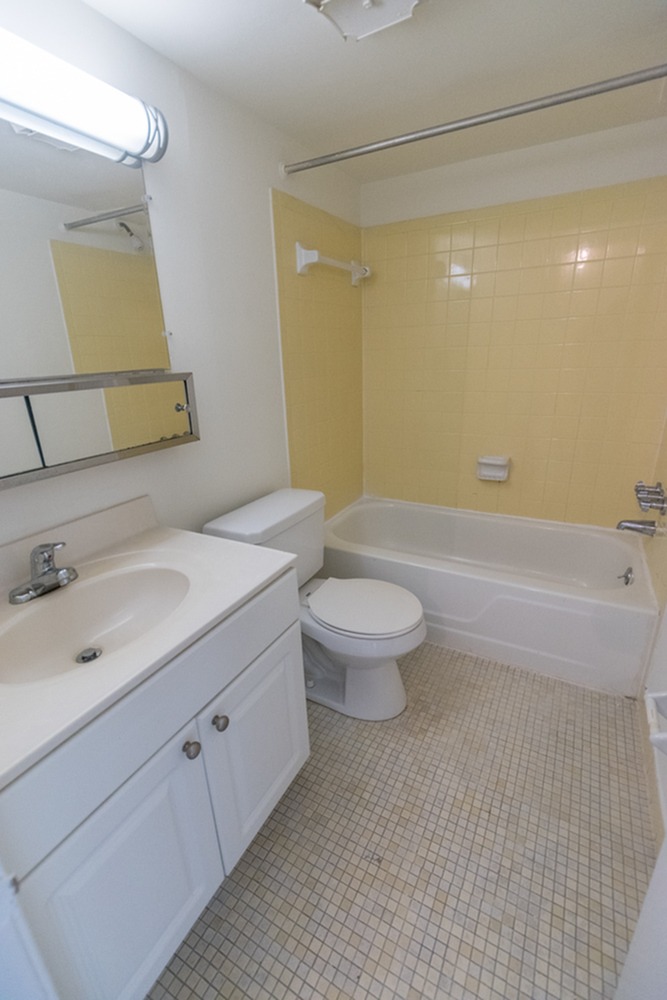 Bathroom with tiled flooring and a tub and shower at The Lafayette