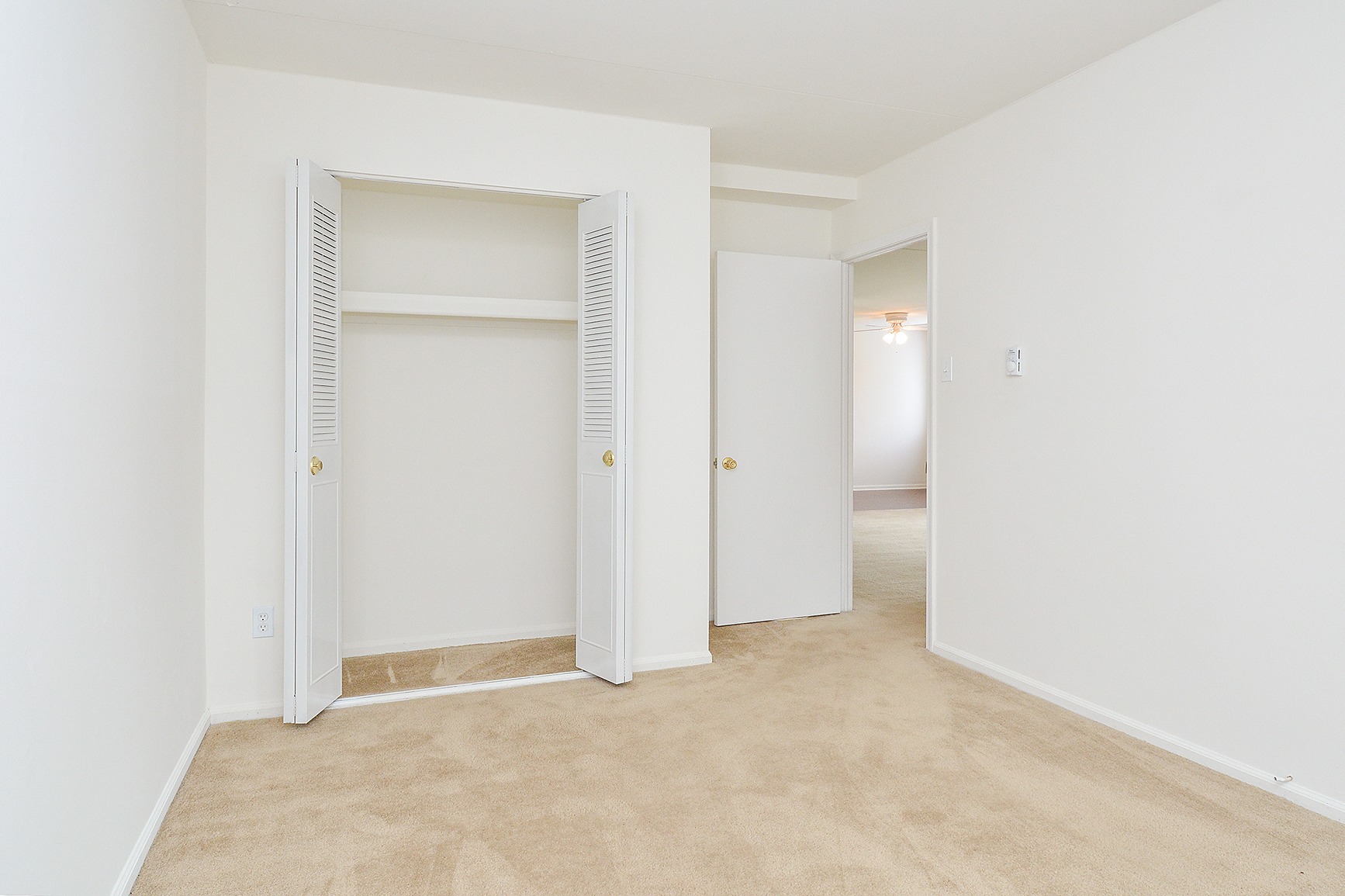 Carpeted bedroom with a closet in an apartment at Gulph Mills Village.