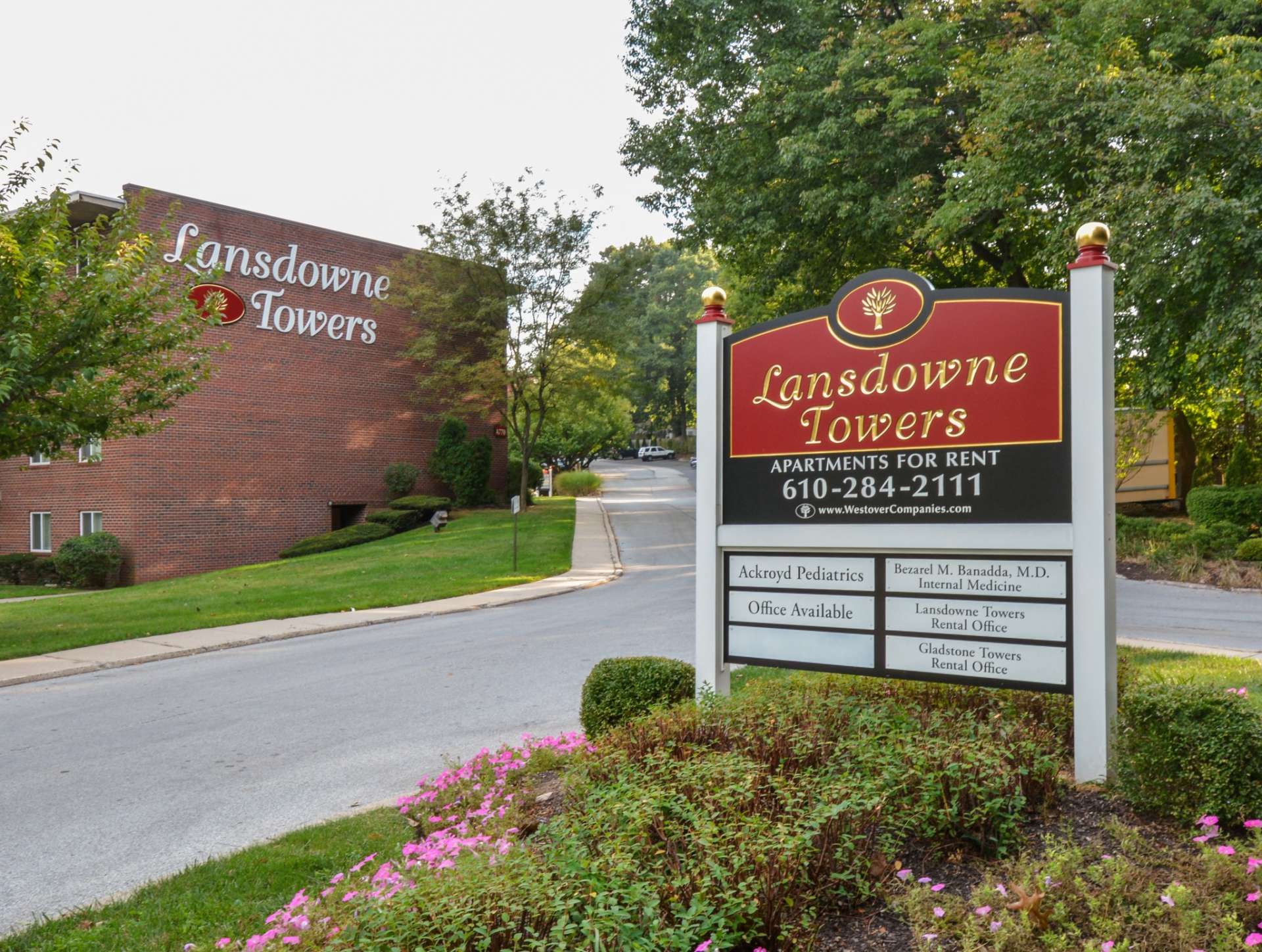 Lansdowne Towers entrance sign with a variety of bushes and flowers around the sign.