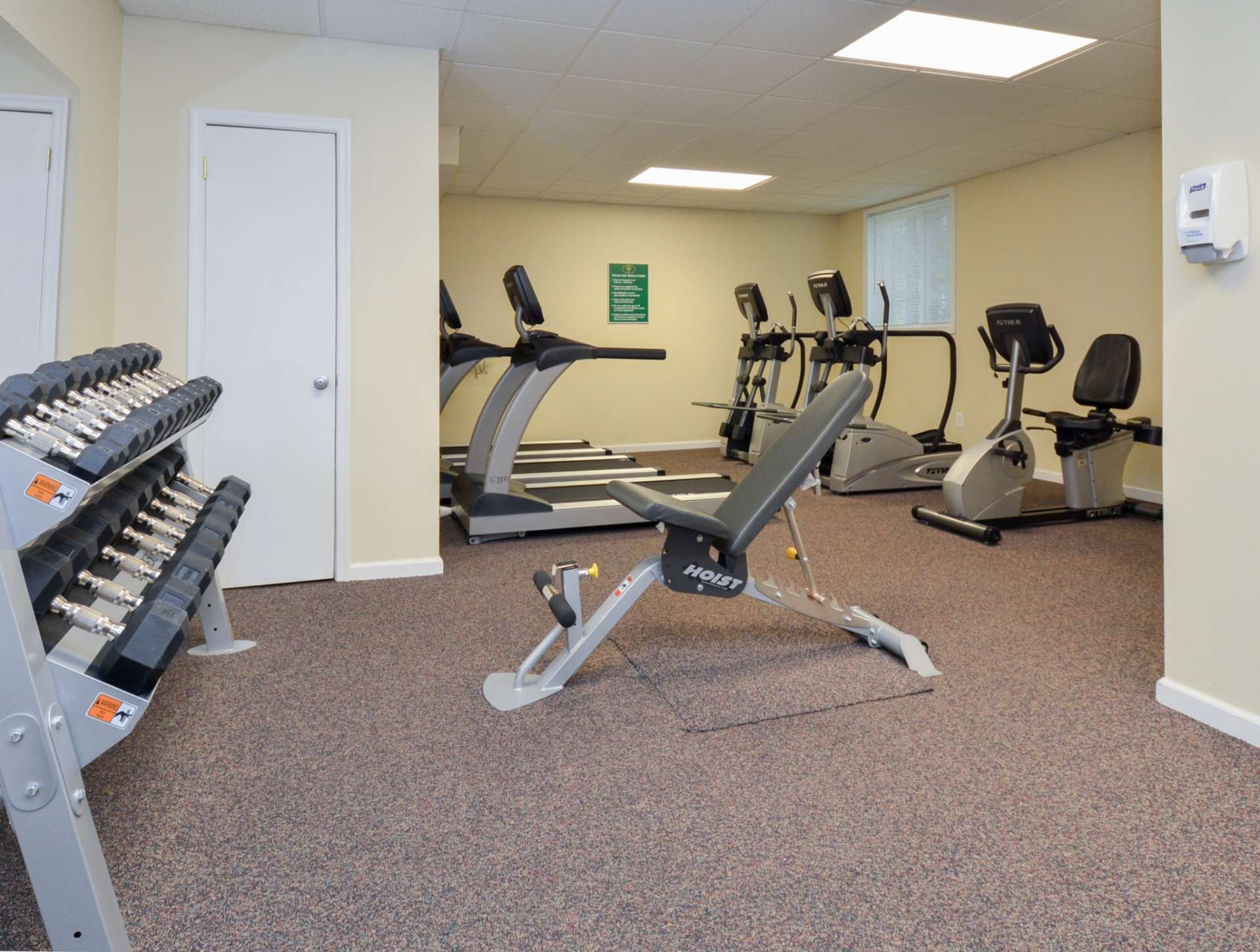 Indoor gym with a variety of workout equipment at Lansdowne Towers.