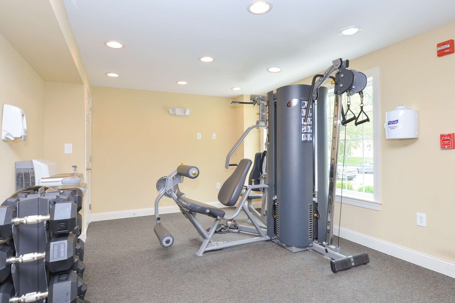 Various workout equipment in an indoor gym at Greenville on 141 Apartments and Townhomes.