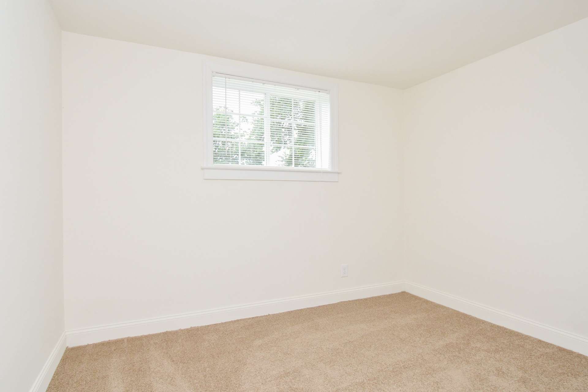 Carpeted bedroom with a window at Greenville on 141.