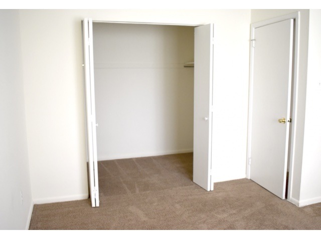 Living room area of an apartment, fitted with a walk-in closet space