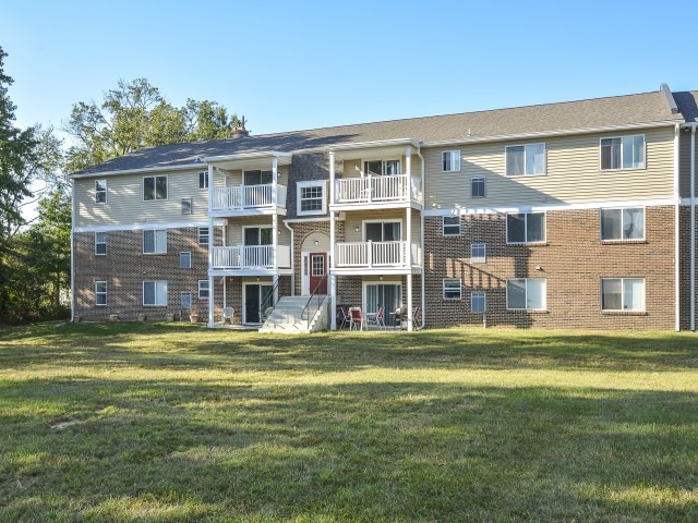 Exterior of an apartment building , fitted with steps, and a lawn
