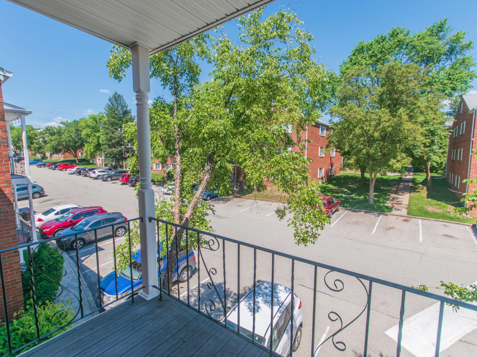 Balcony of an apartment at Jamestown Village with a view of the parking lot and other apartment buildings.