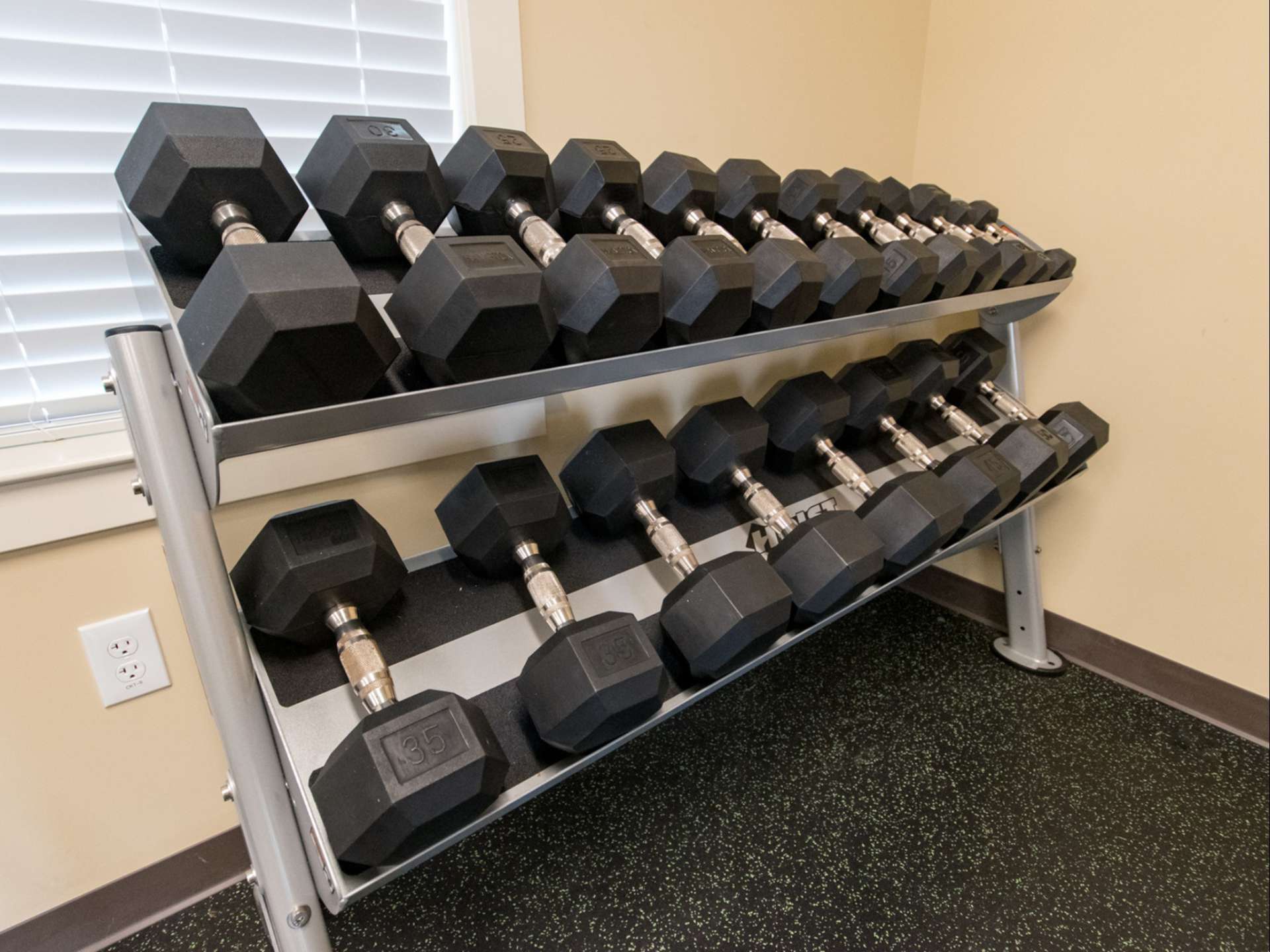 A rack of weights at an indoor gym at Lake Club Apartments.