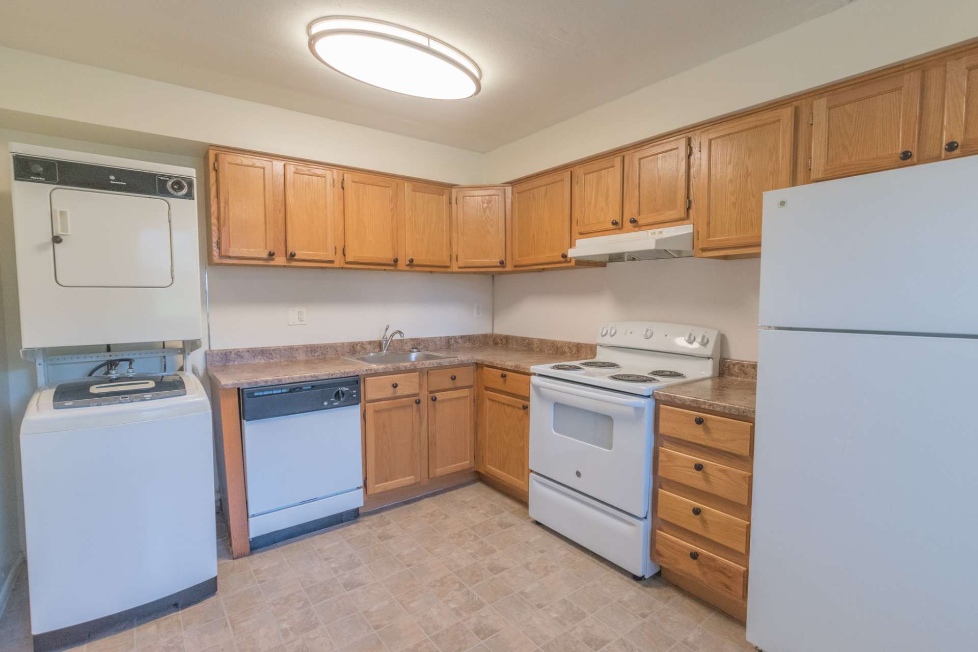 Willow Run Apartments kitchen with brown cabinets and white appliances