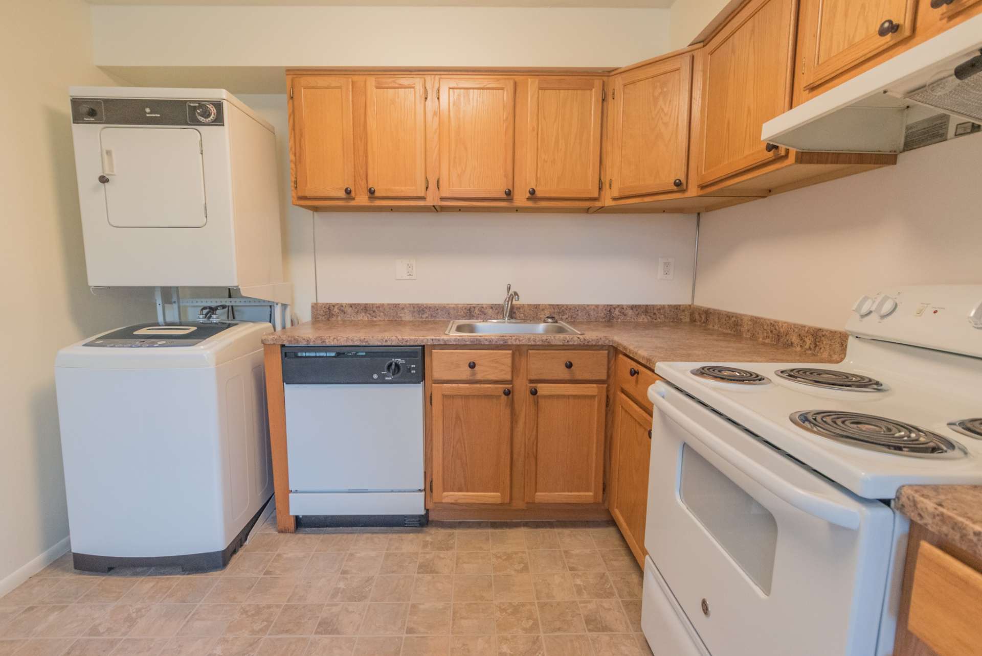 Willow Run apartments kitchen with white appliances and wood cabinets