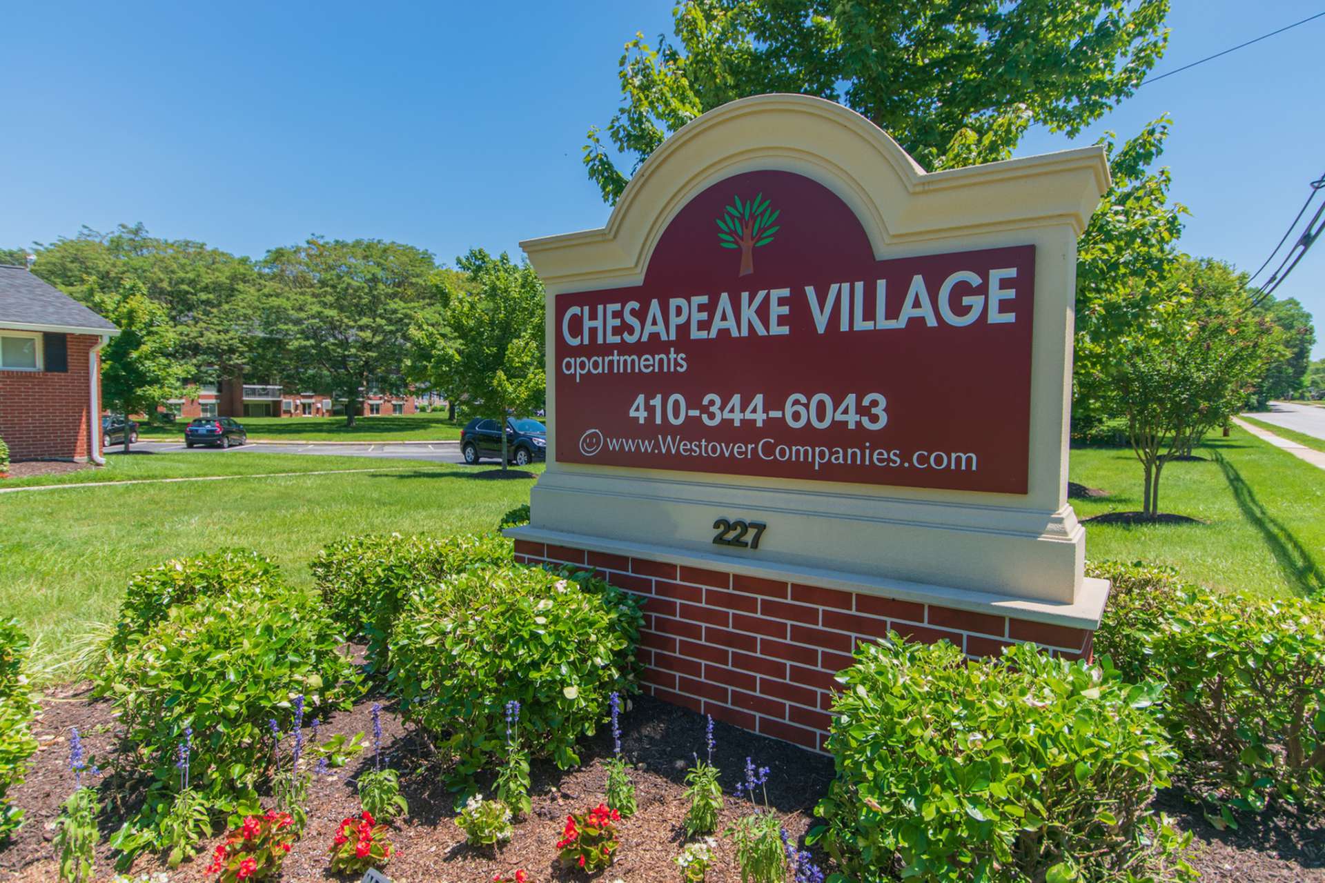 Chesapeake Village apartments welcome sign, fitted in a beautiful garden