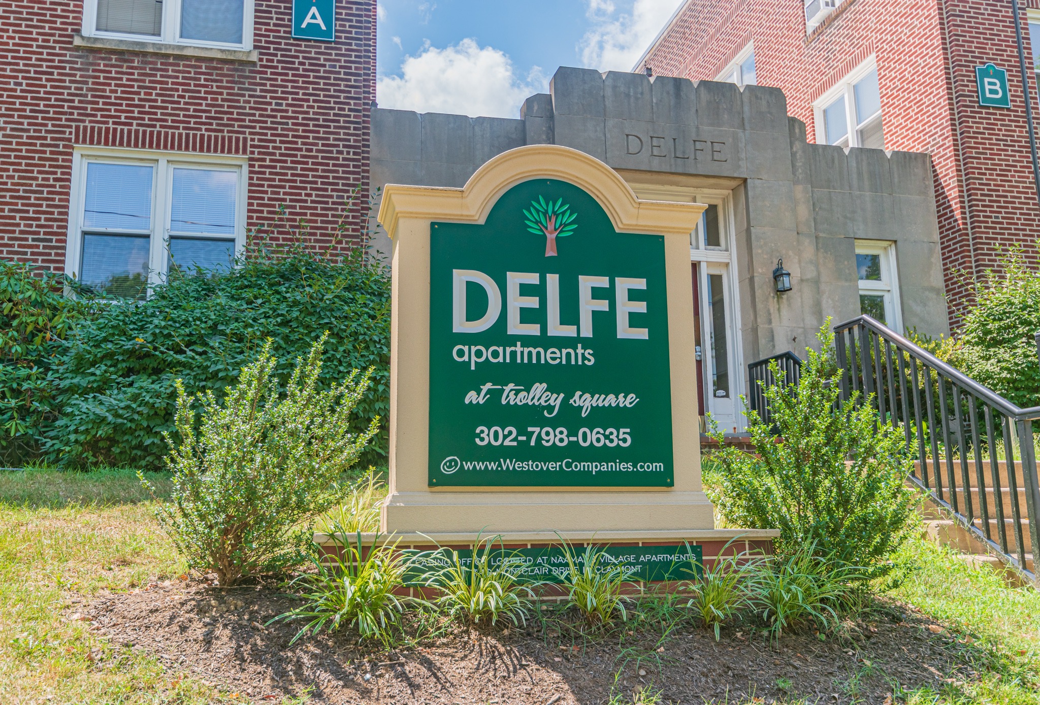 Delfe apartments welcome sign, fitted in a beautiful garden