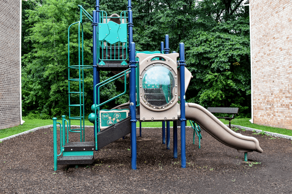 Playground area of our community, fitted with a kids slide, in a play box