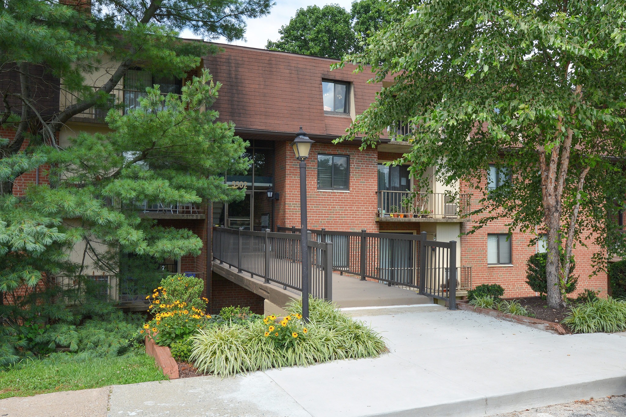 Exterior of an apartment building at Fairway Park, fitted with concrete flooring, railing, and lighting