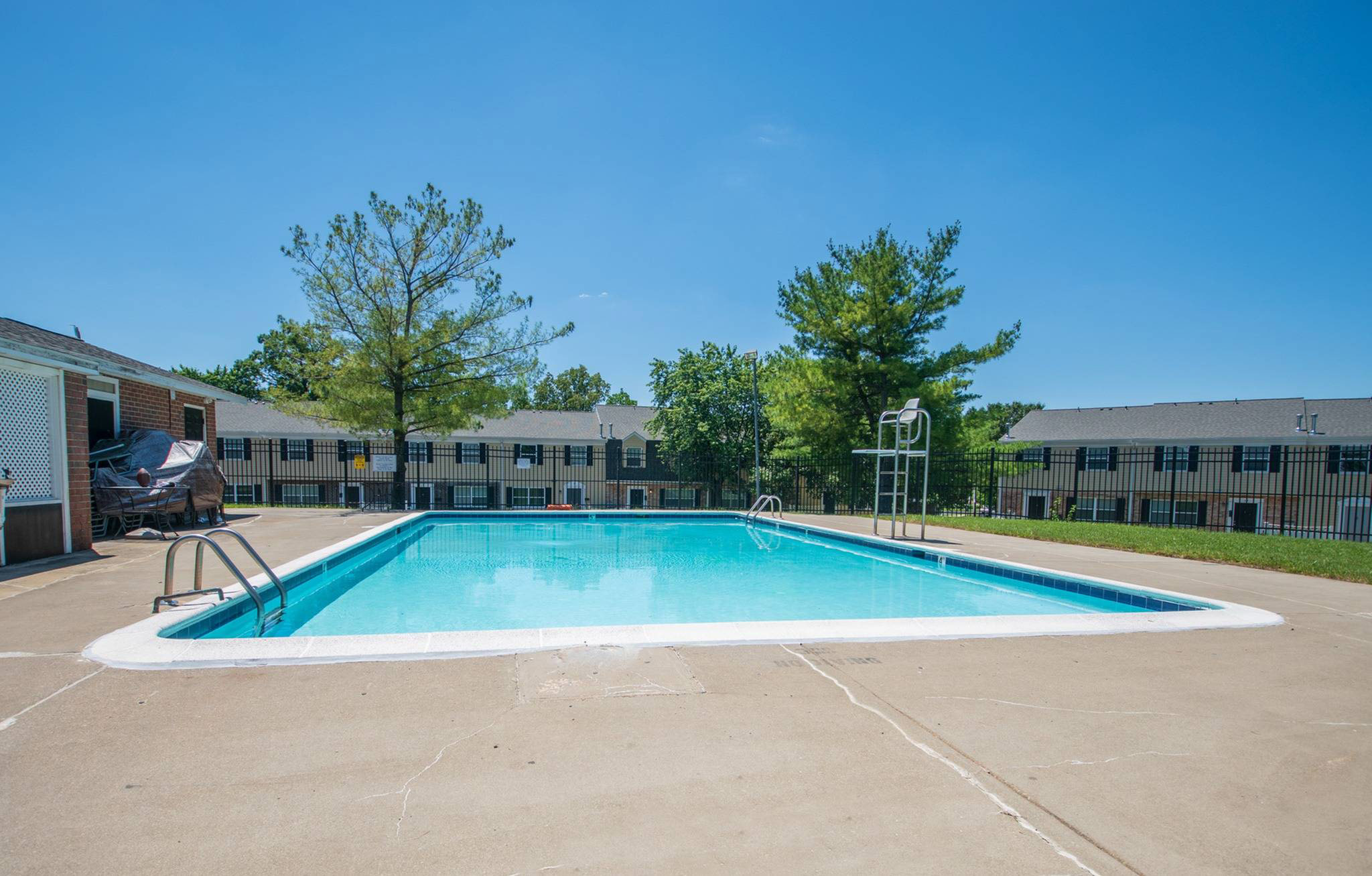 Fenced-in outdoor pool area at Middle River Townhomes.
