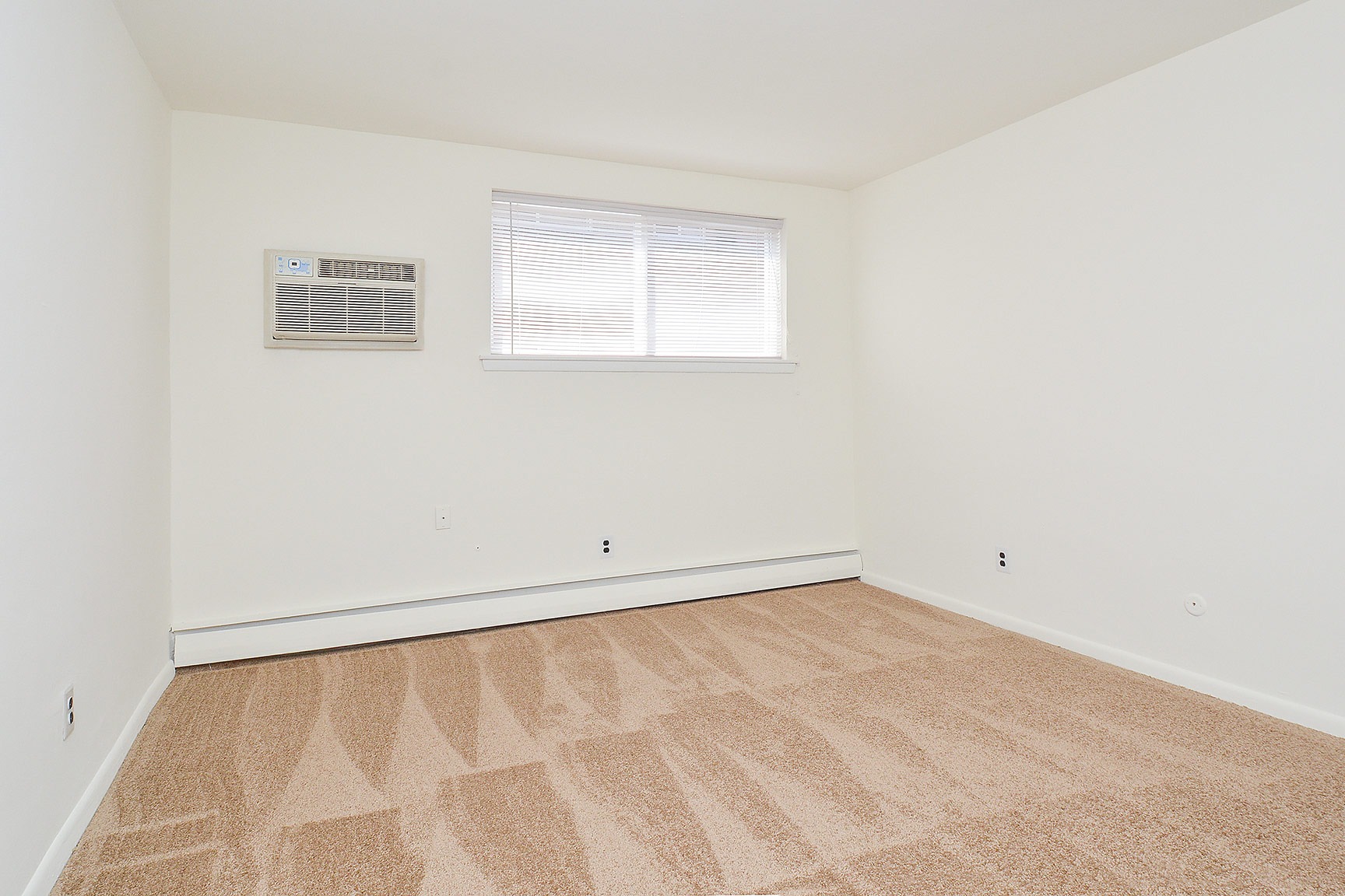 Woodview Apartments living room with in-wall air conditioner