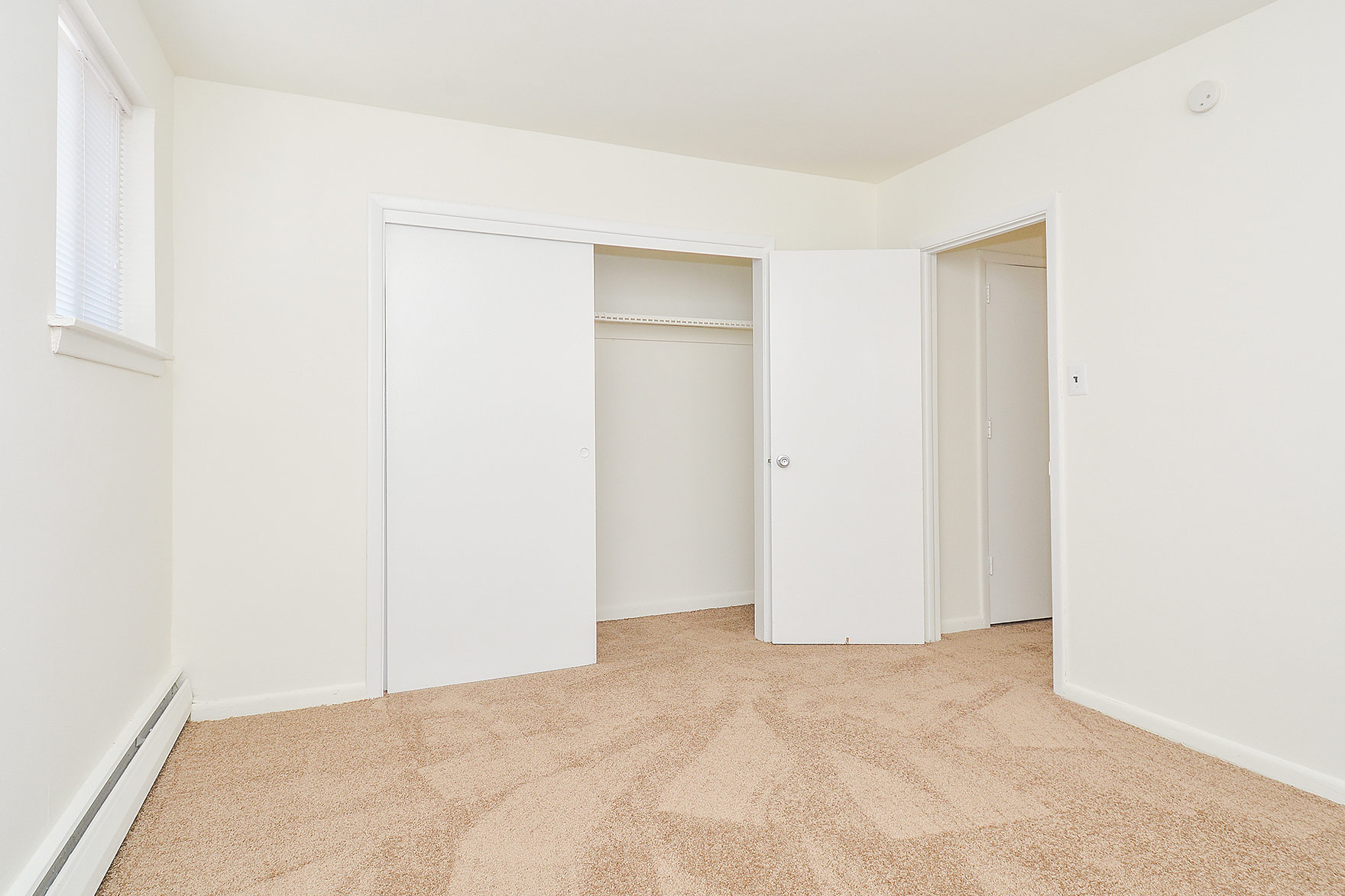 Woodview Apartments carpeted bedroom with a closet