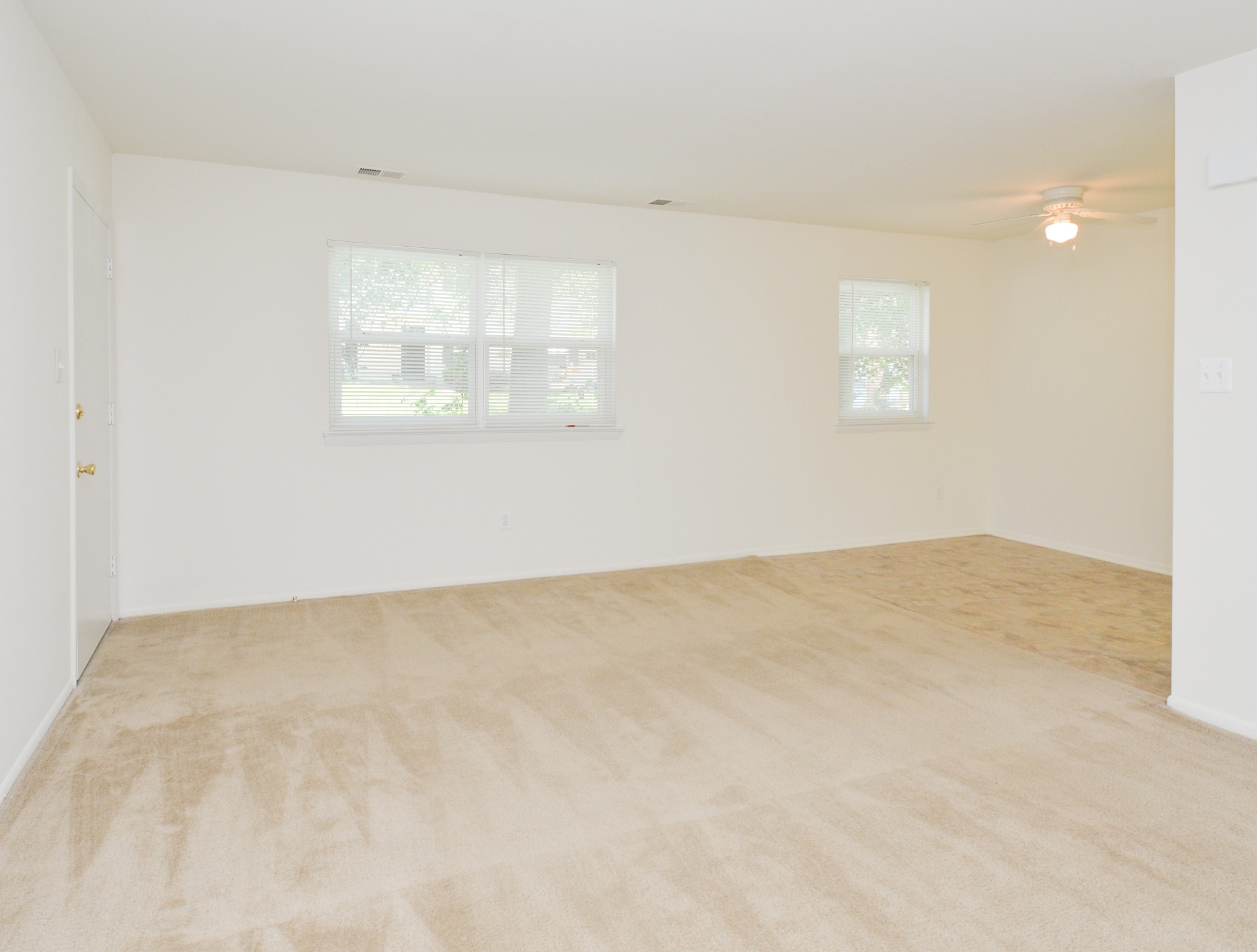 Rolling Glen living and dining area with window and carpeting