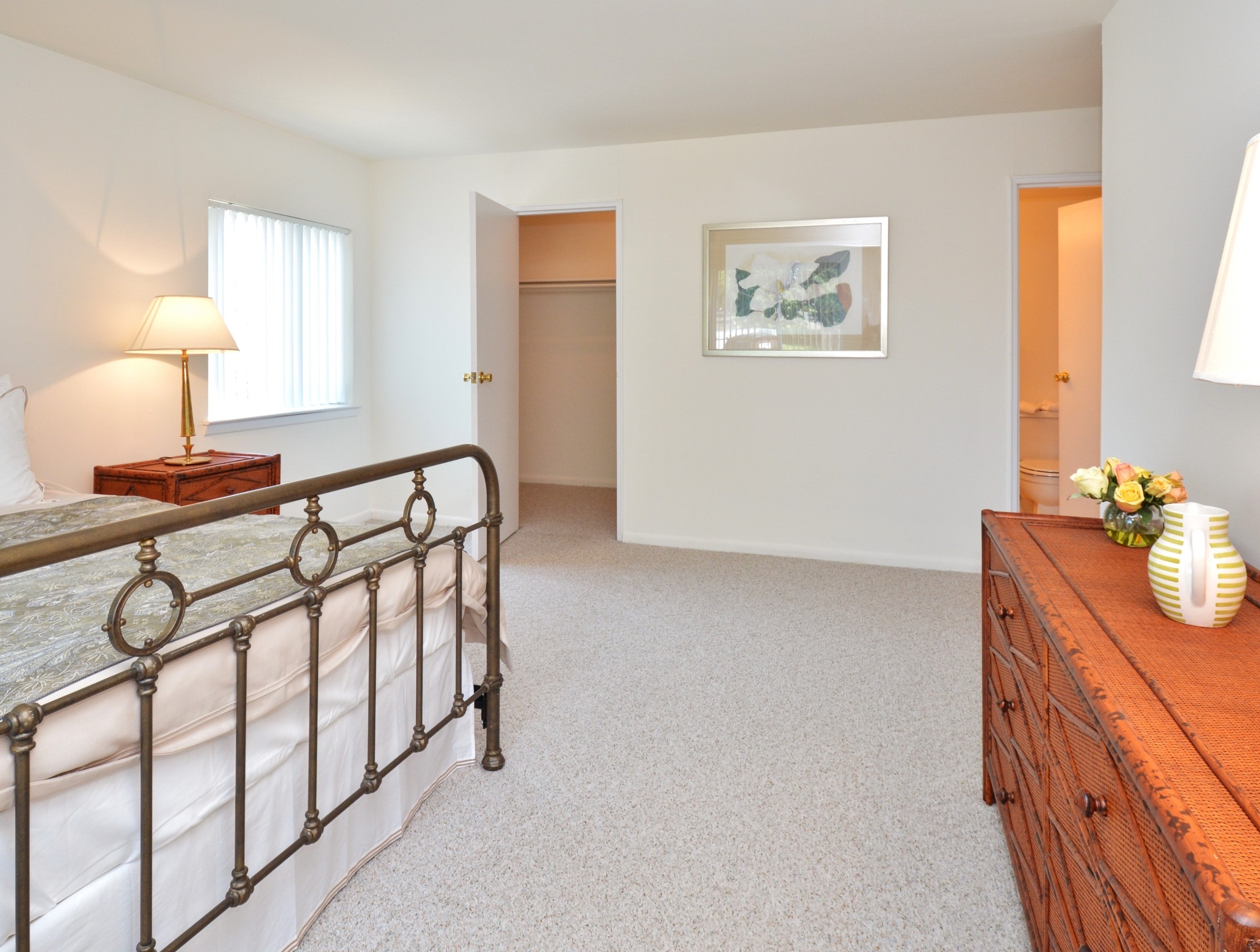 A bedroom at Valley Stream Apartments with carpeting and a closet