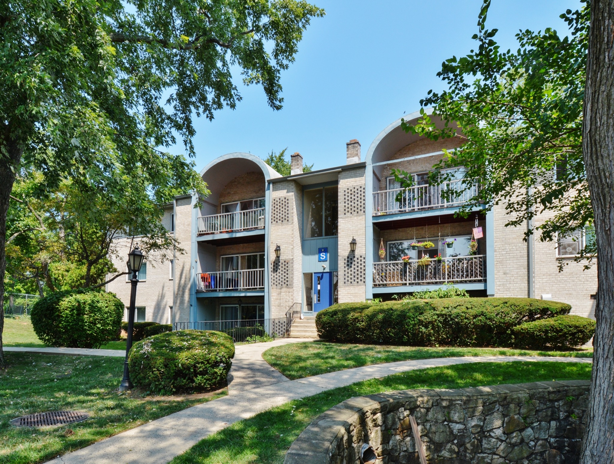 Valley Stream apartments exterior with balconies and foliage