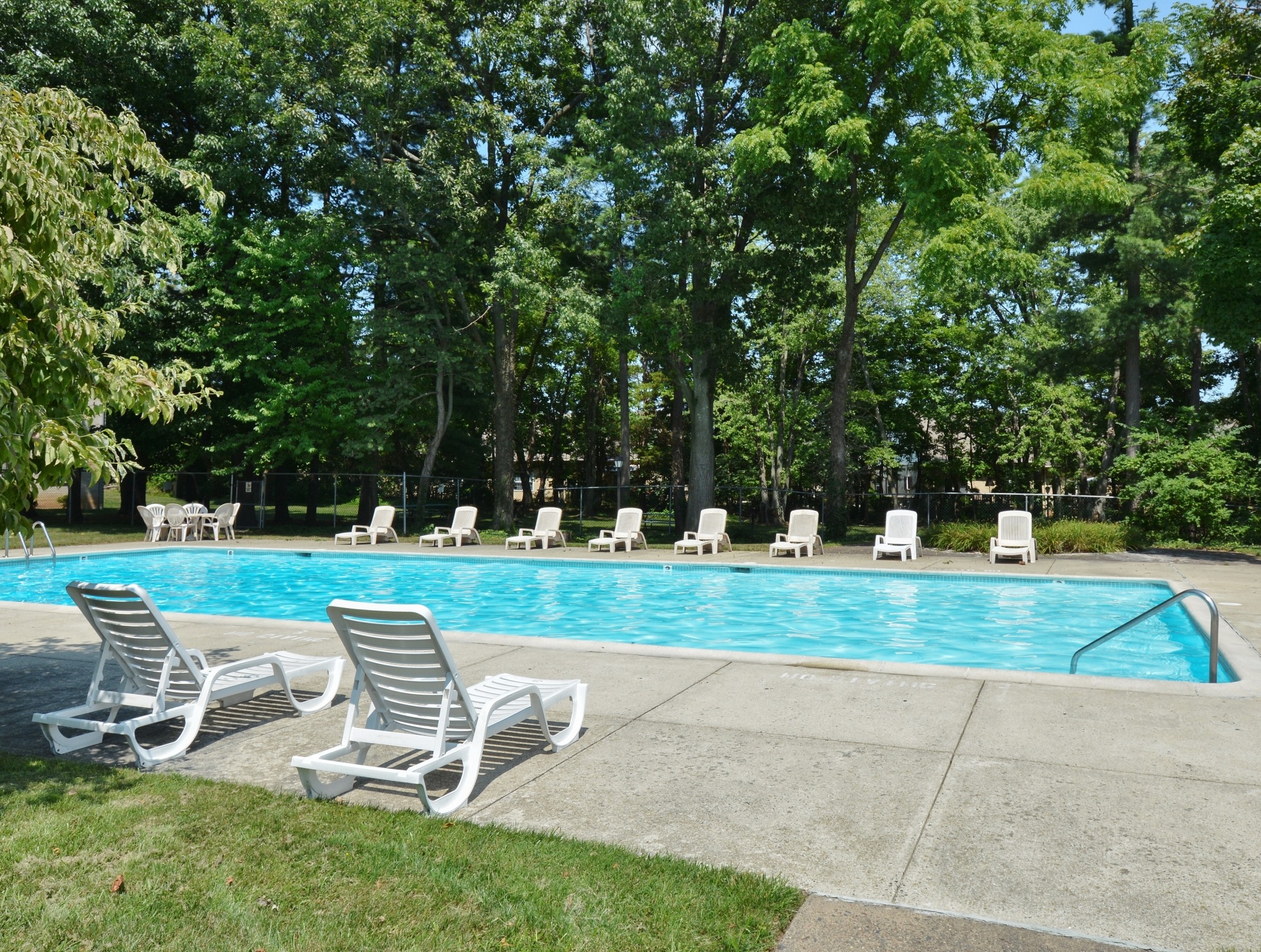 A large dazzling pool with loungers at Valley Stream Apartments