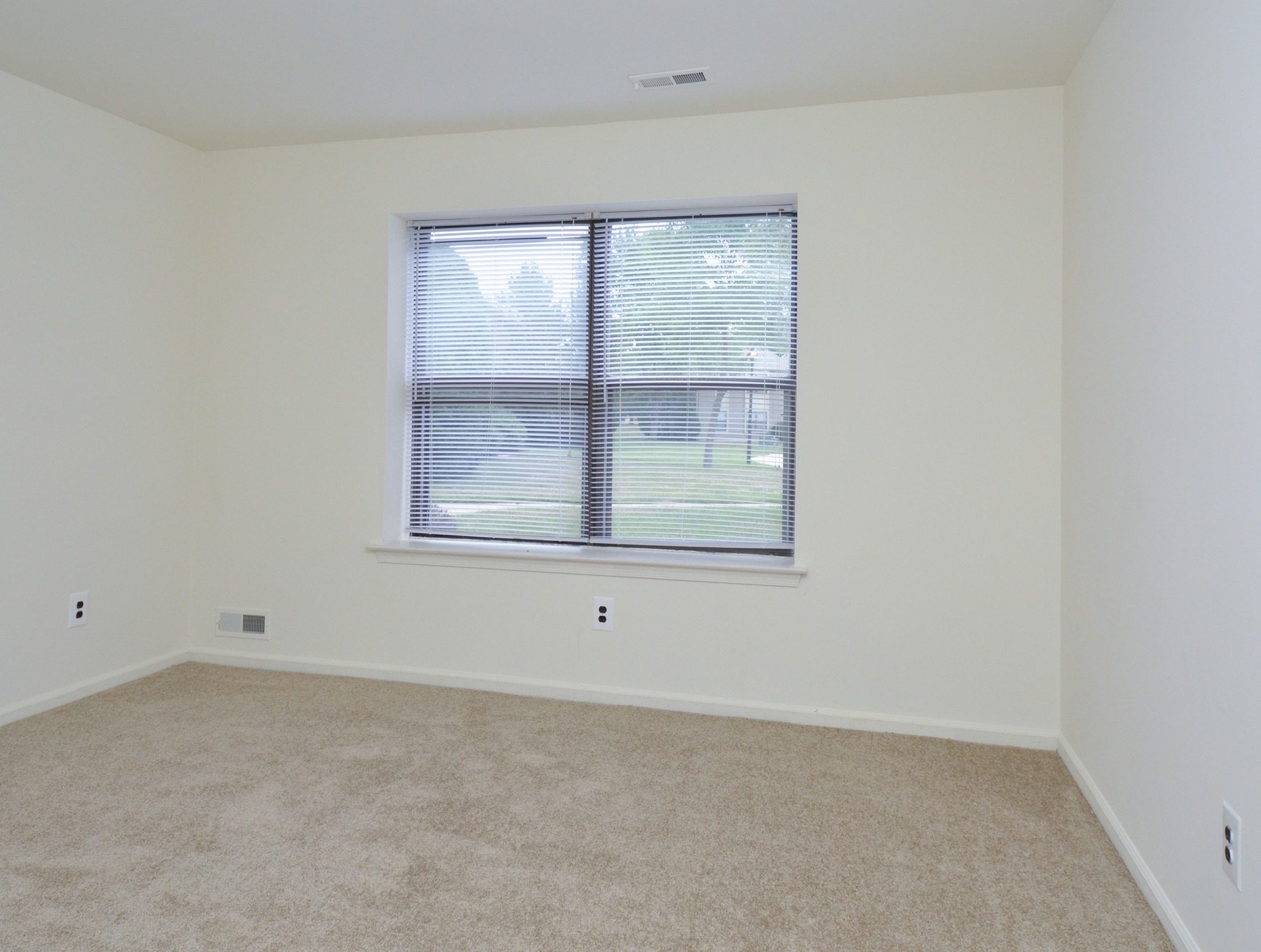 Willow Ridge carpeted bedroom with window