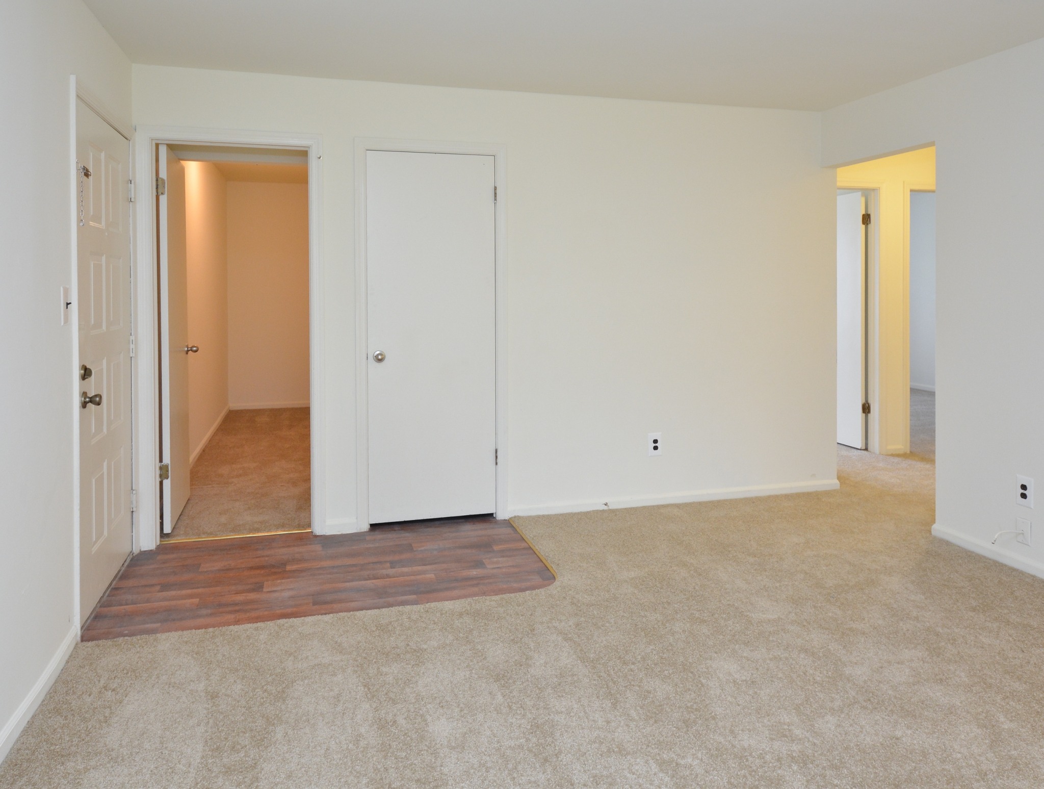 Willow Ridge carpeted living room with hallway door.
