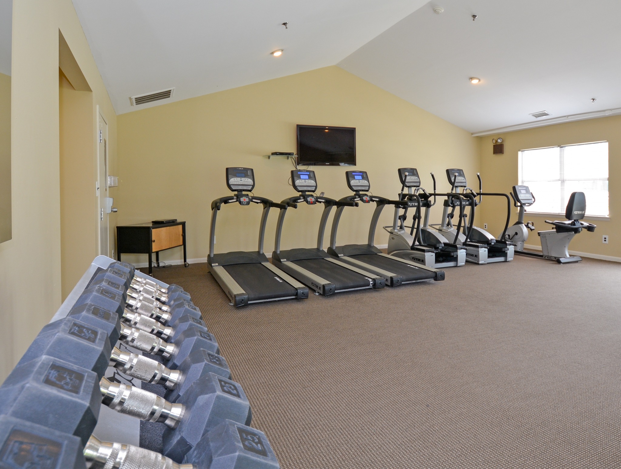 Willow Ridge Village fitness center with TV.