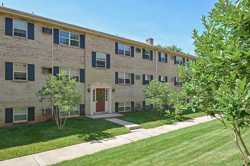 Exterior of an apartment building in Claymont, DE with sidewalks and landscaped yards.