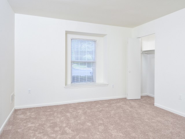 Victoria Crossing carpeted bedroom with a window