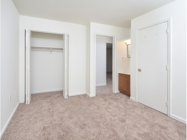 Victoria Crossing bedroom with carpeting and a closet