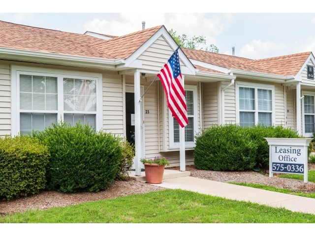 The exterior of the leasing office with an American flag at the Upper Deerfield Estates