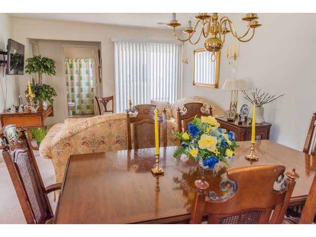 The dining area and living room with a hallway leading to the bathroom at the Upper Deerfield Estates