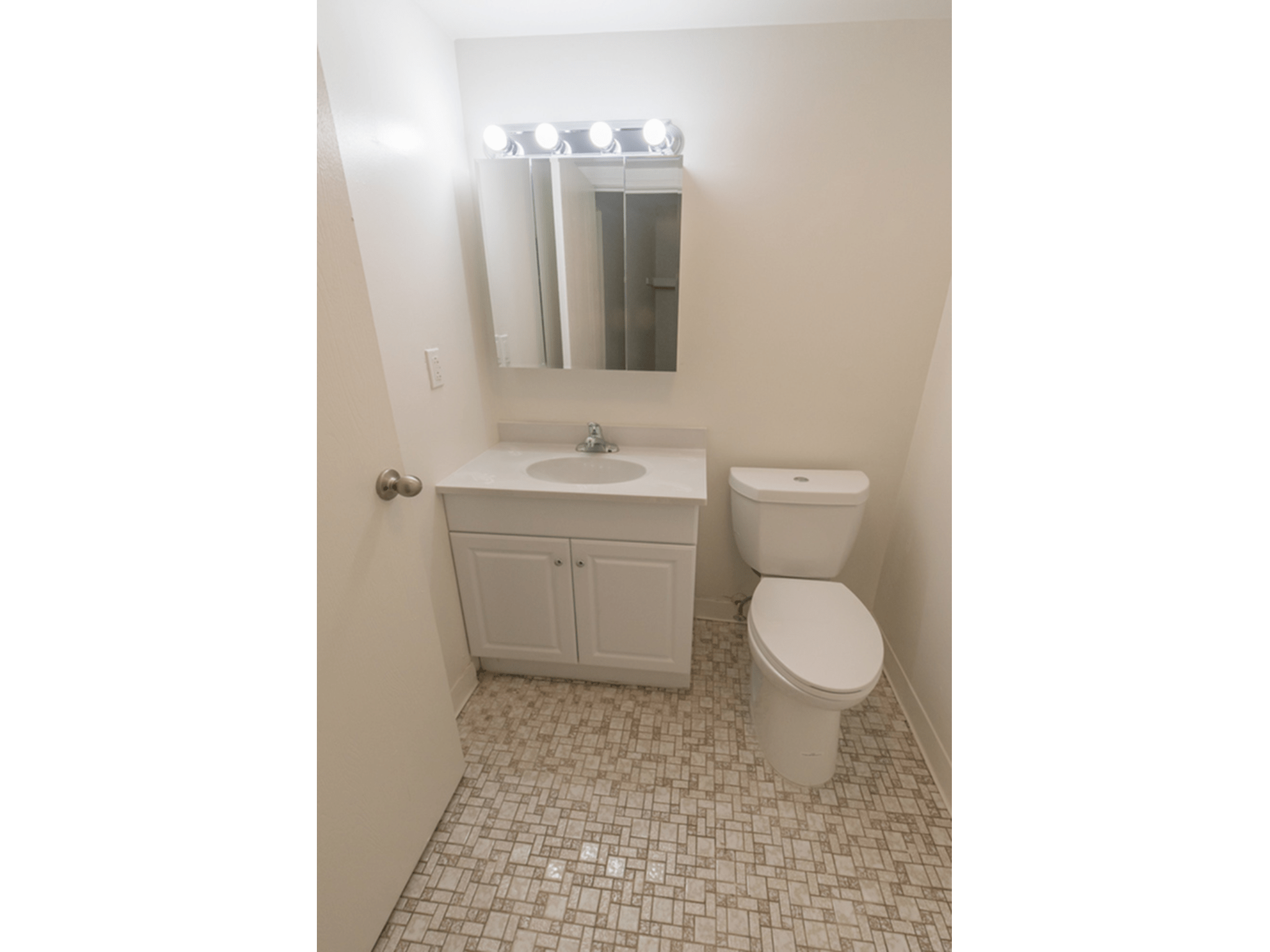 Winslow House Apartments bathroom with vanity and tiles floors